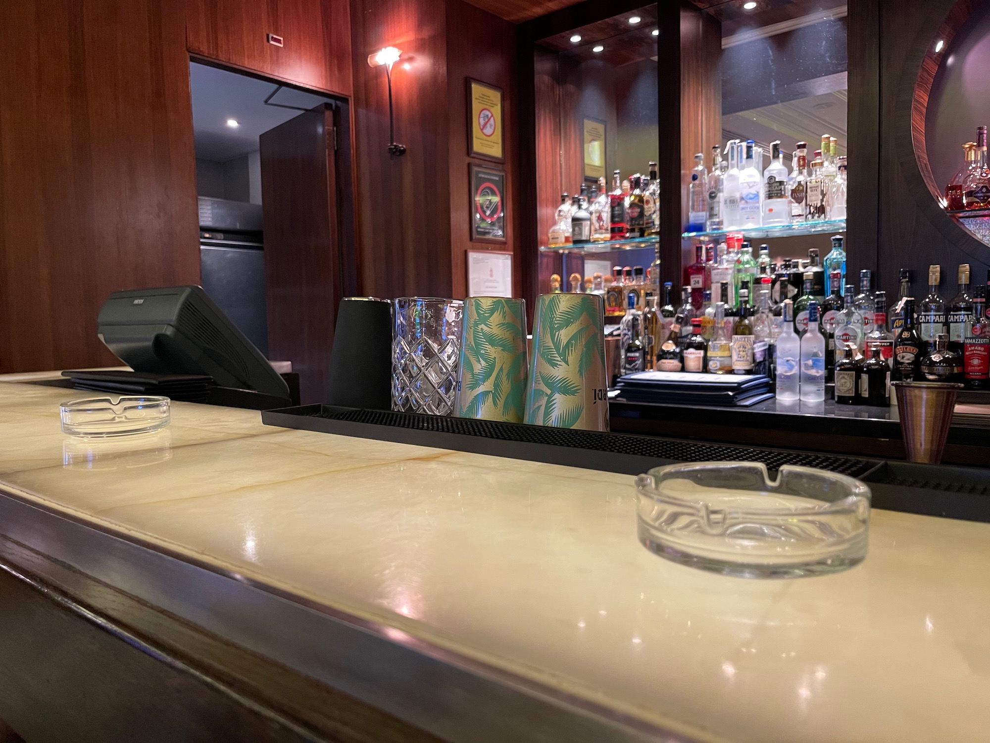 a bar with a glass ashtray and bottles