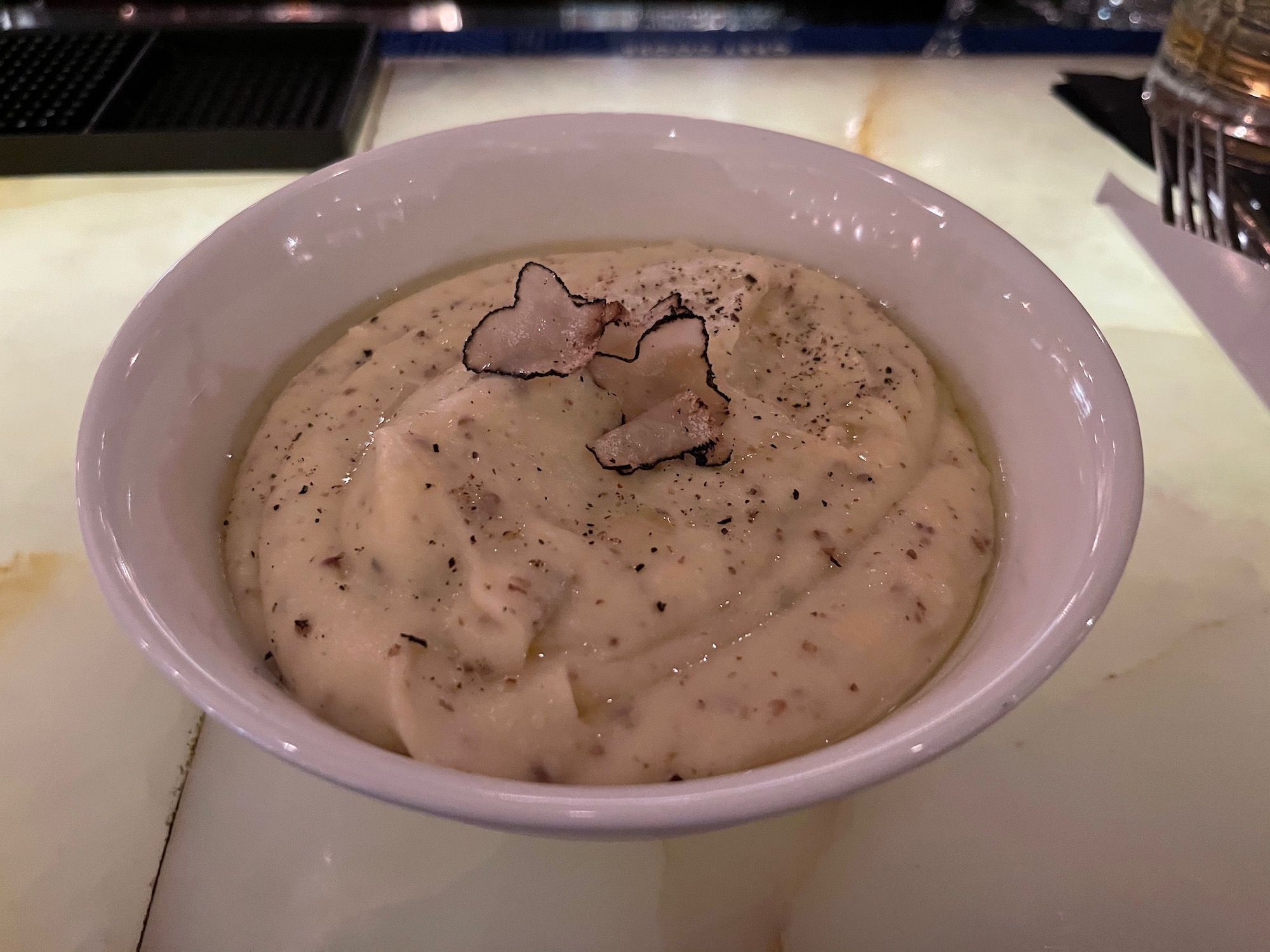 a bowl of food with a black speck on top