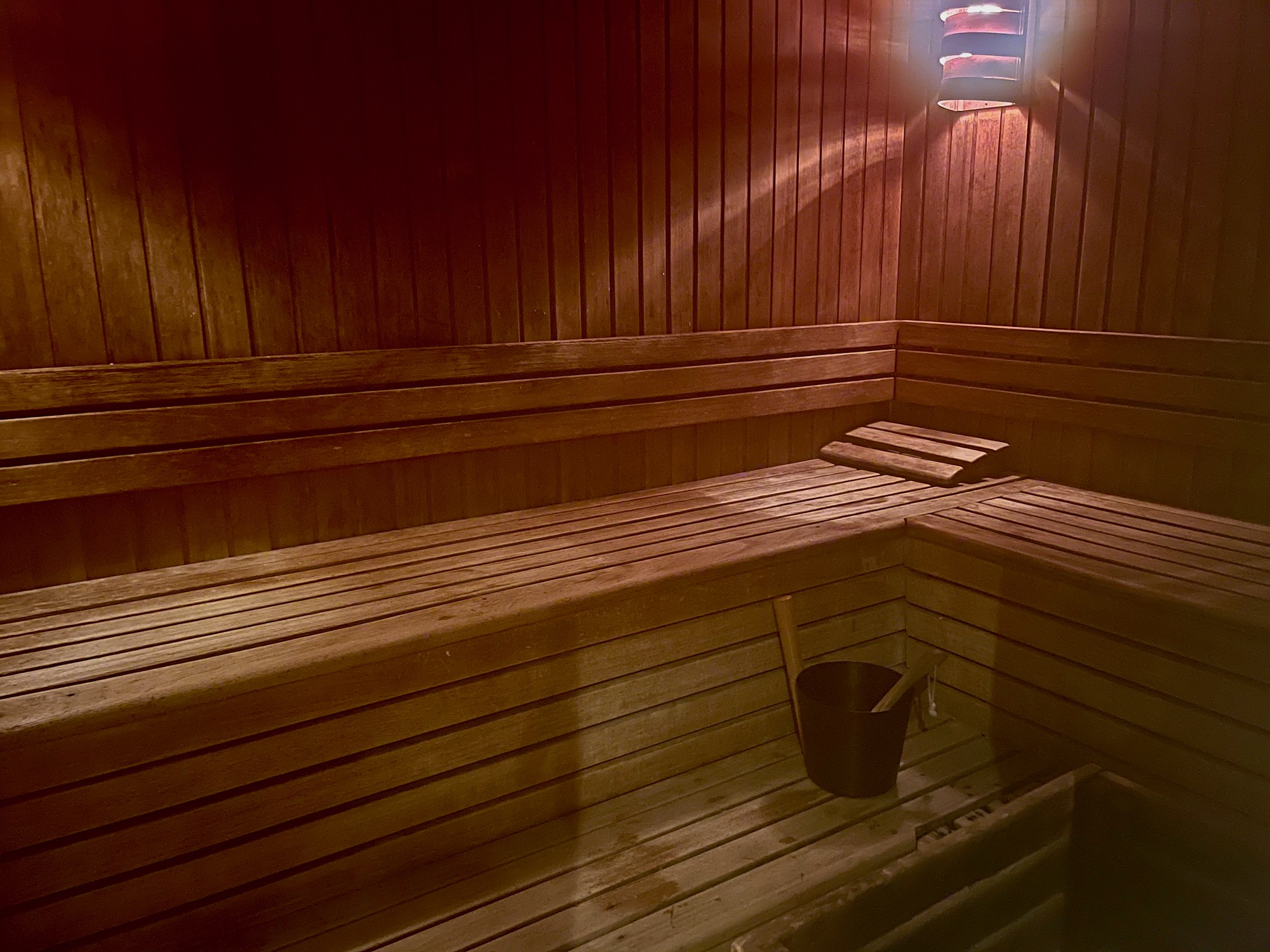 a wooden sauna with a bucket and bucket