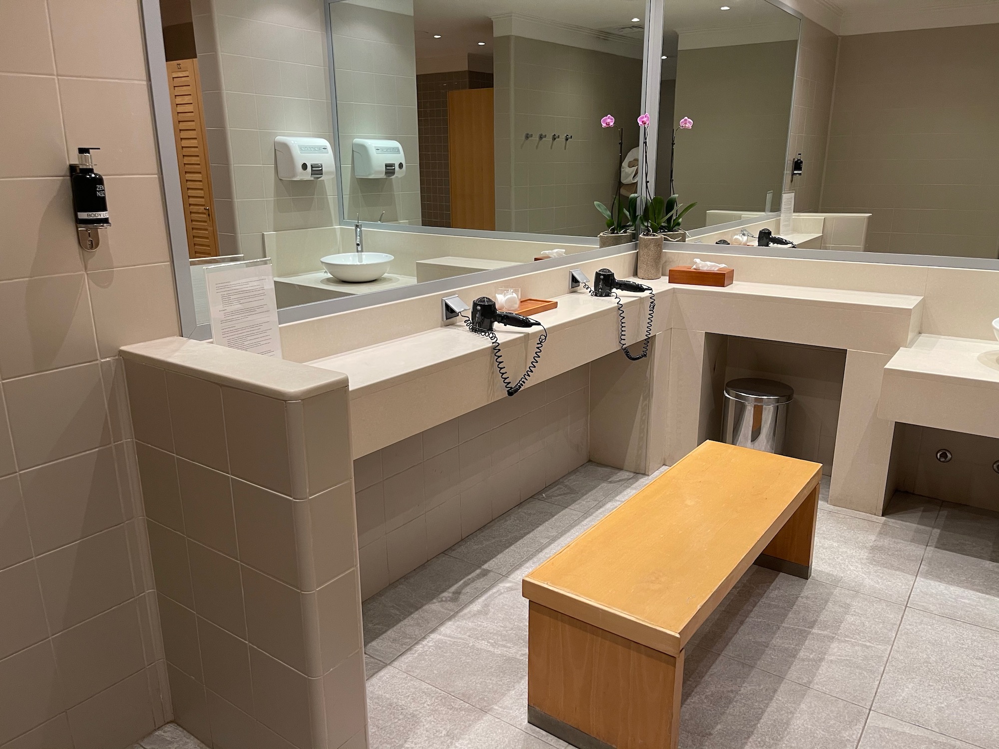 a bathroom with a bench and mirrors