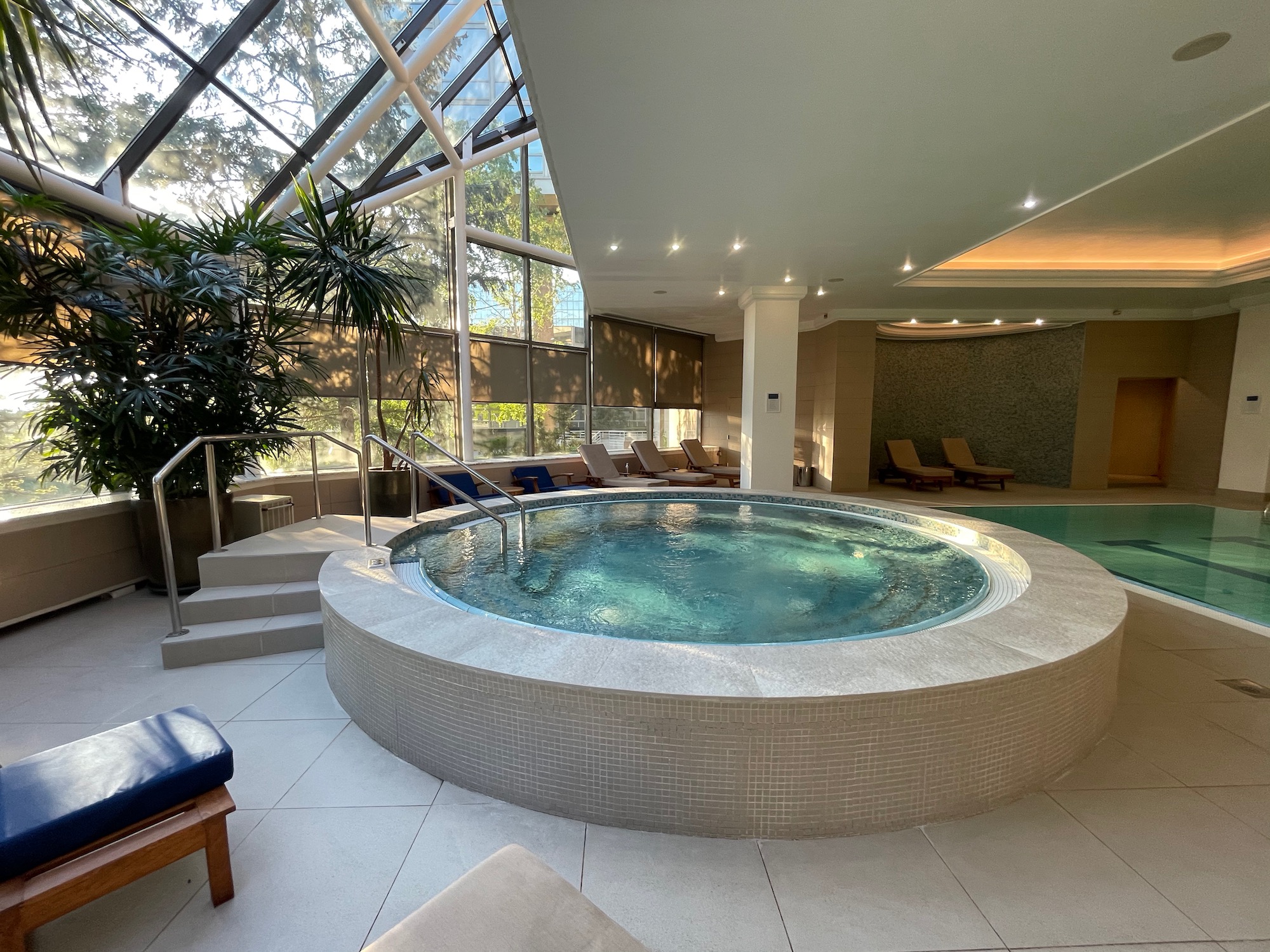 a large indoor hot tub with a pool in the middle