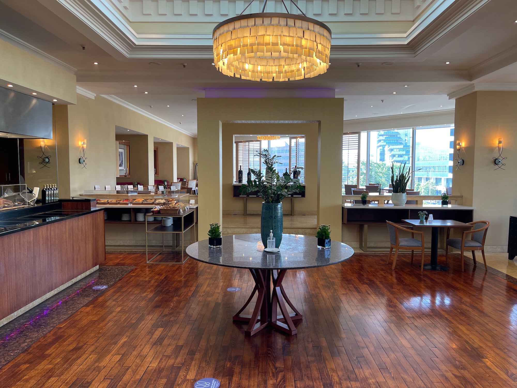 a room with a table and chairs and tables and a chandelier