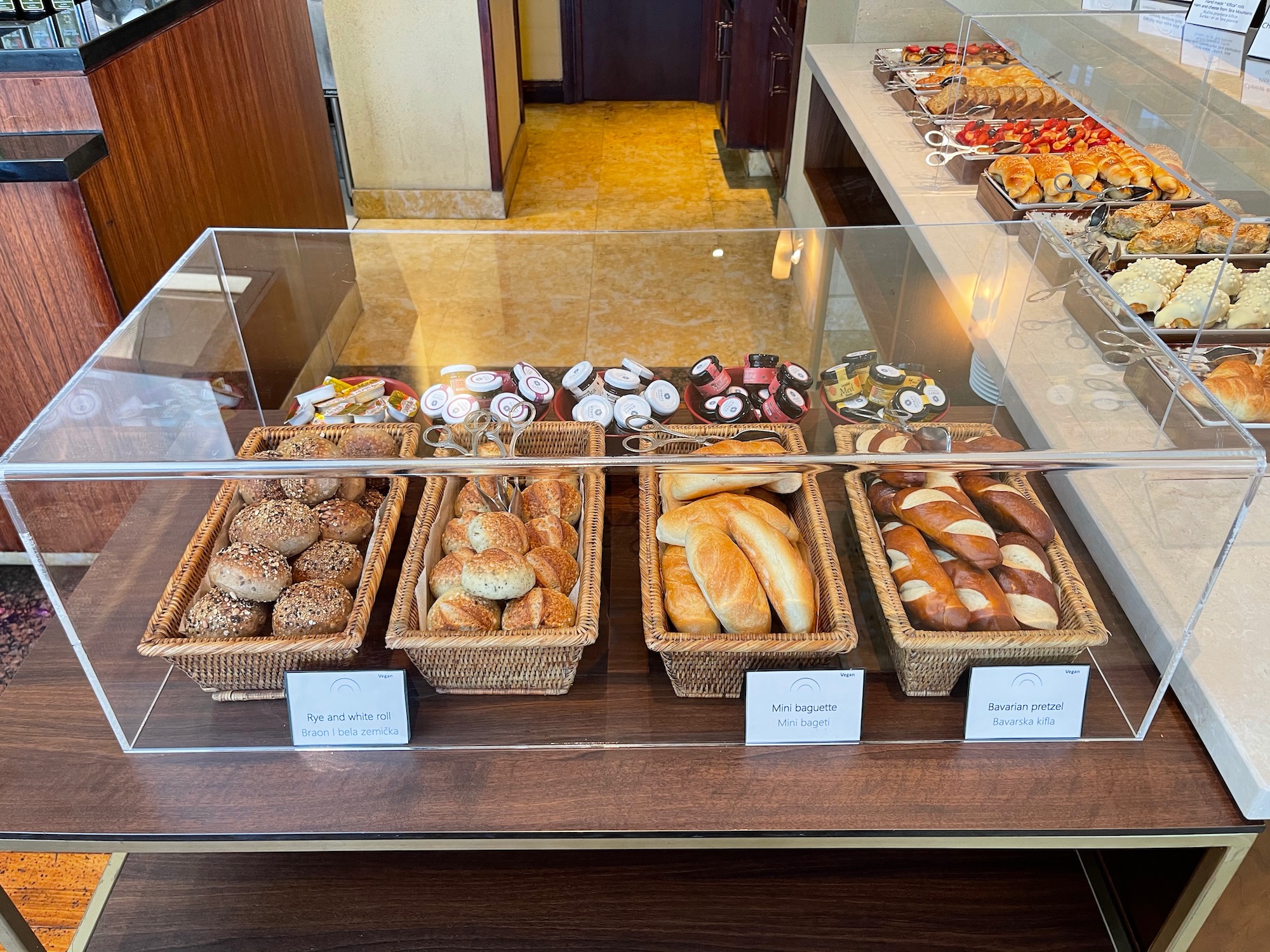 a display case with different types of bread in baskets