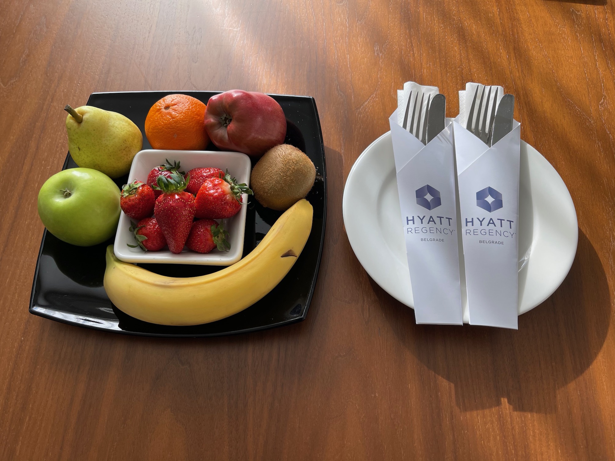 a plate of fruit and a fork on a table