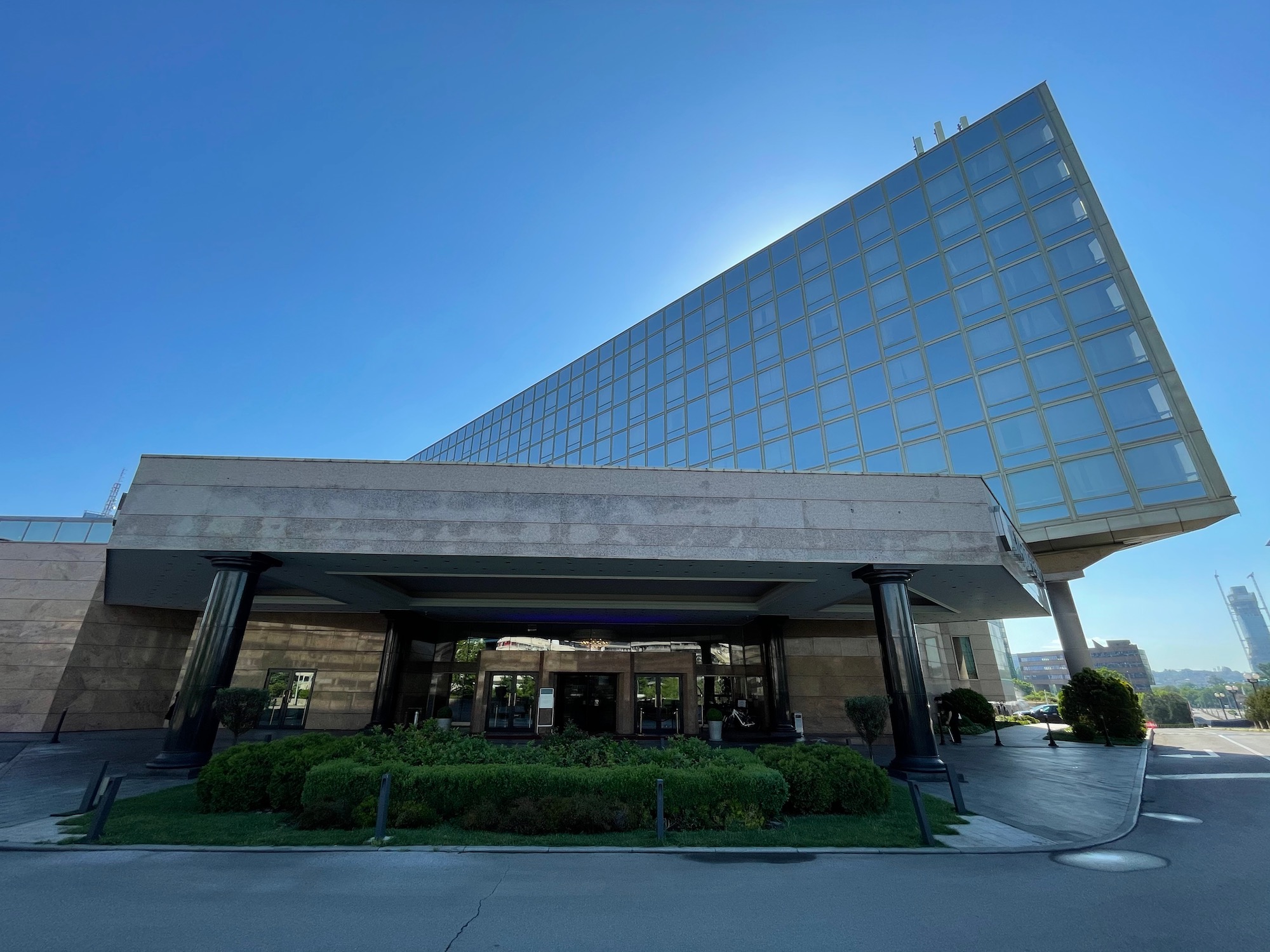 a building with a glass wall and a large building