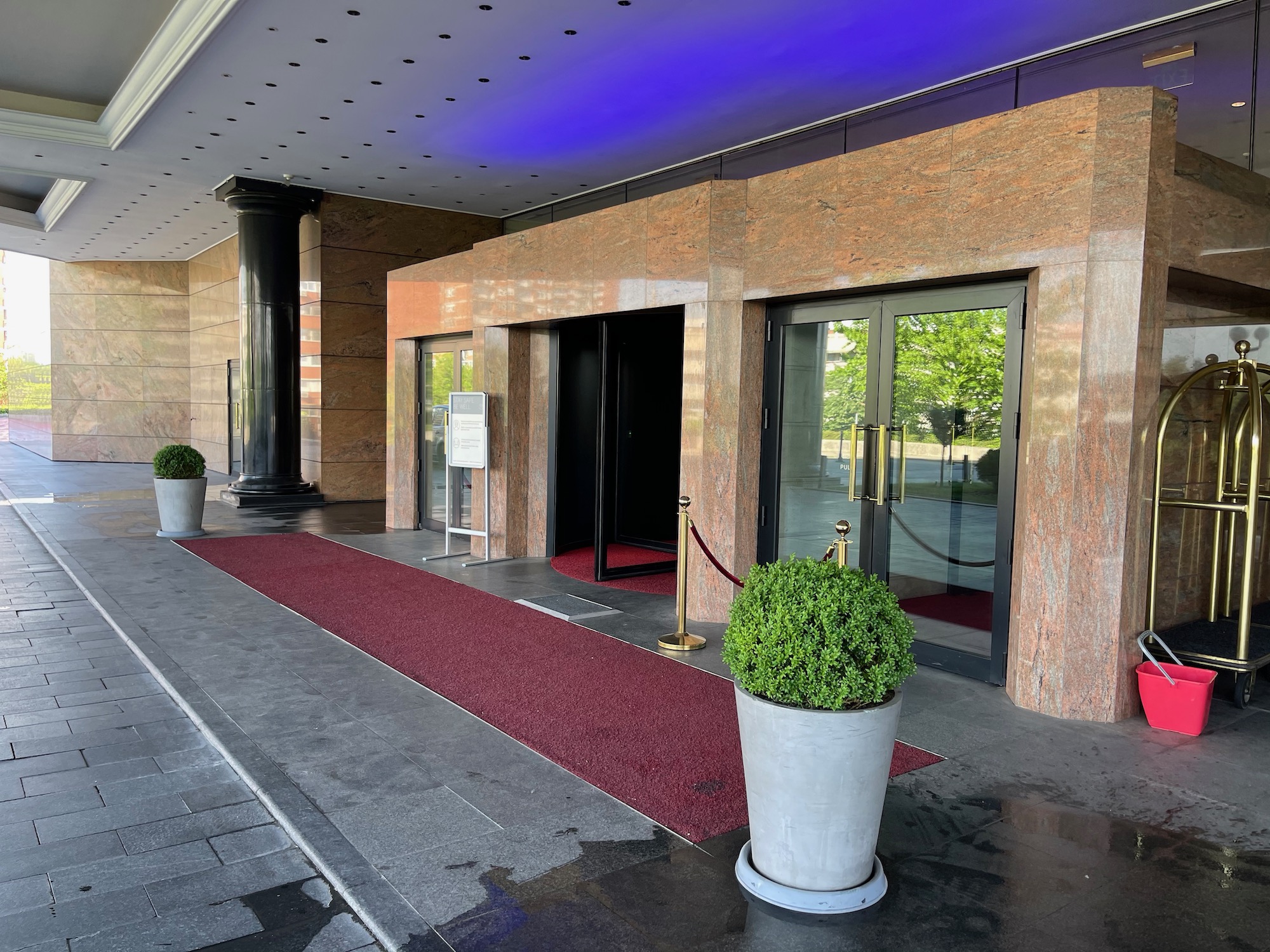 a building with glass doors and red carpet