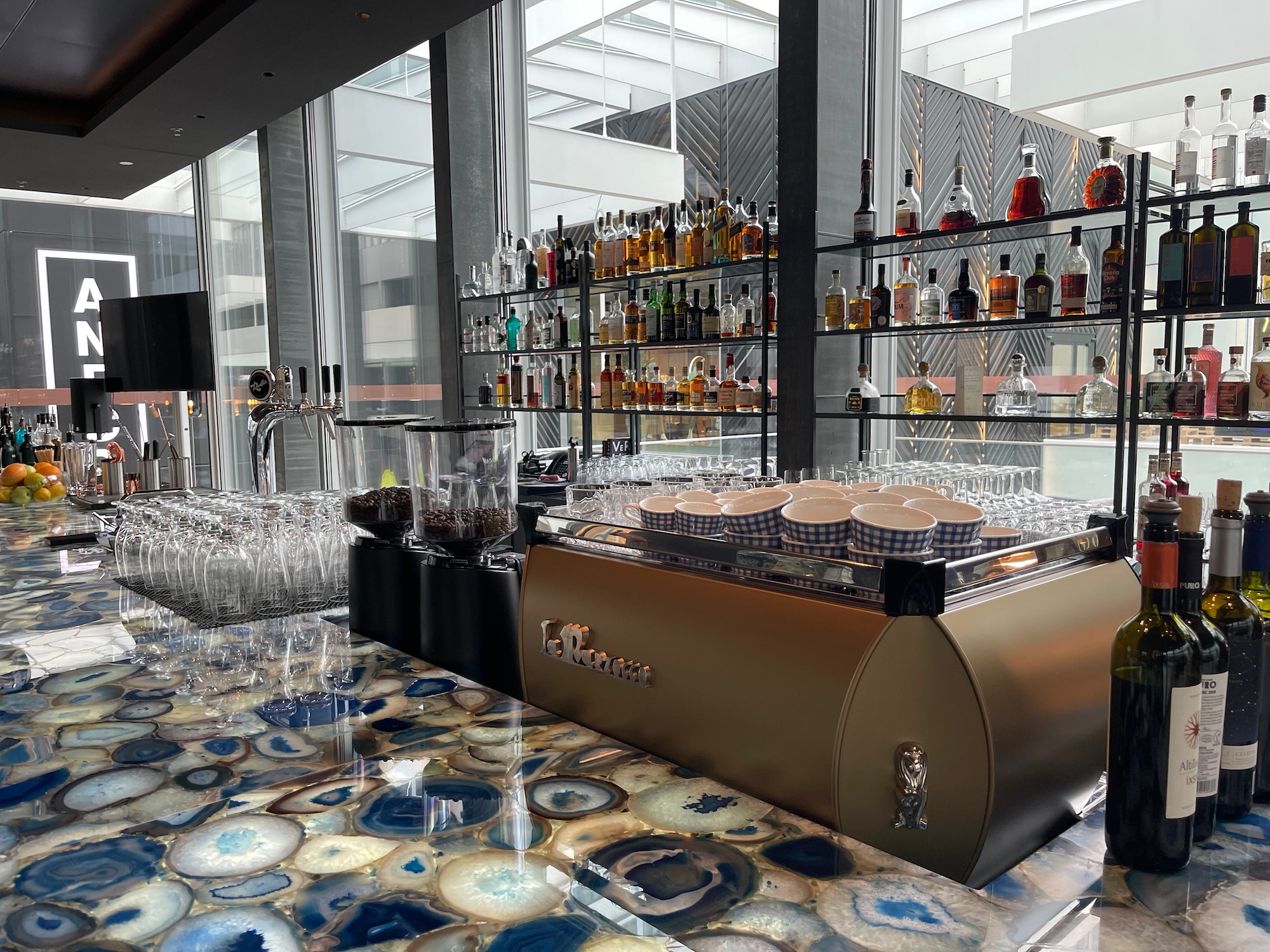 a bar with a counter and shelves of liquor