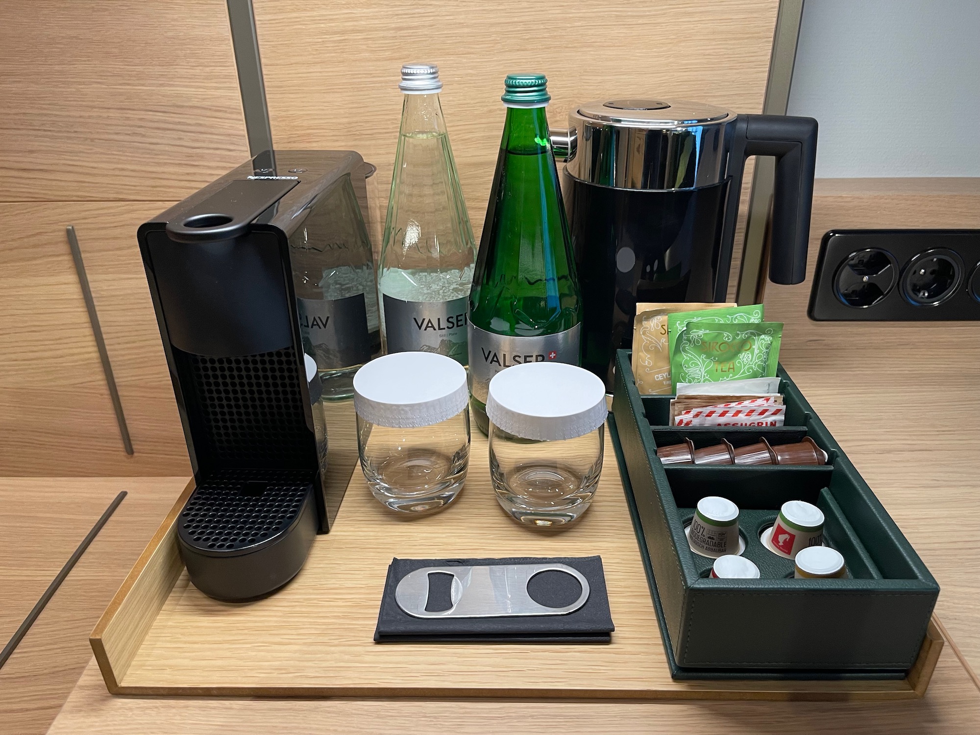 a coffee machine and bottles on a table