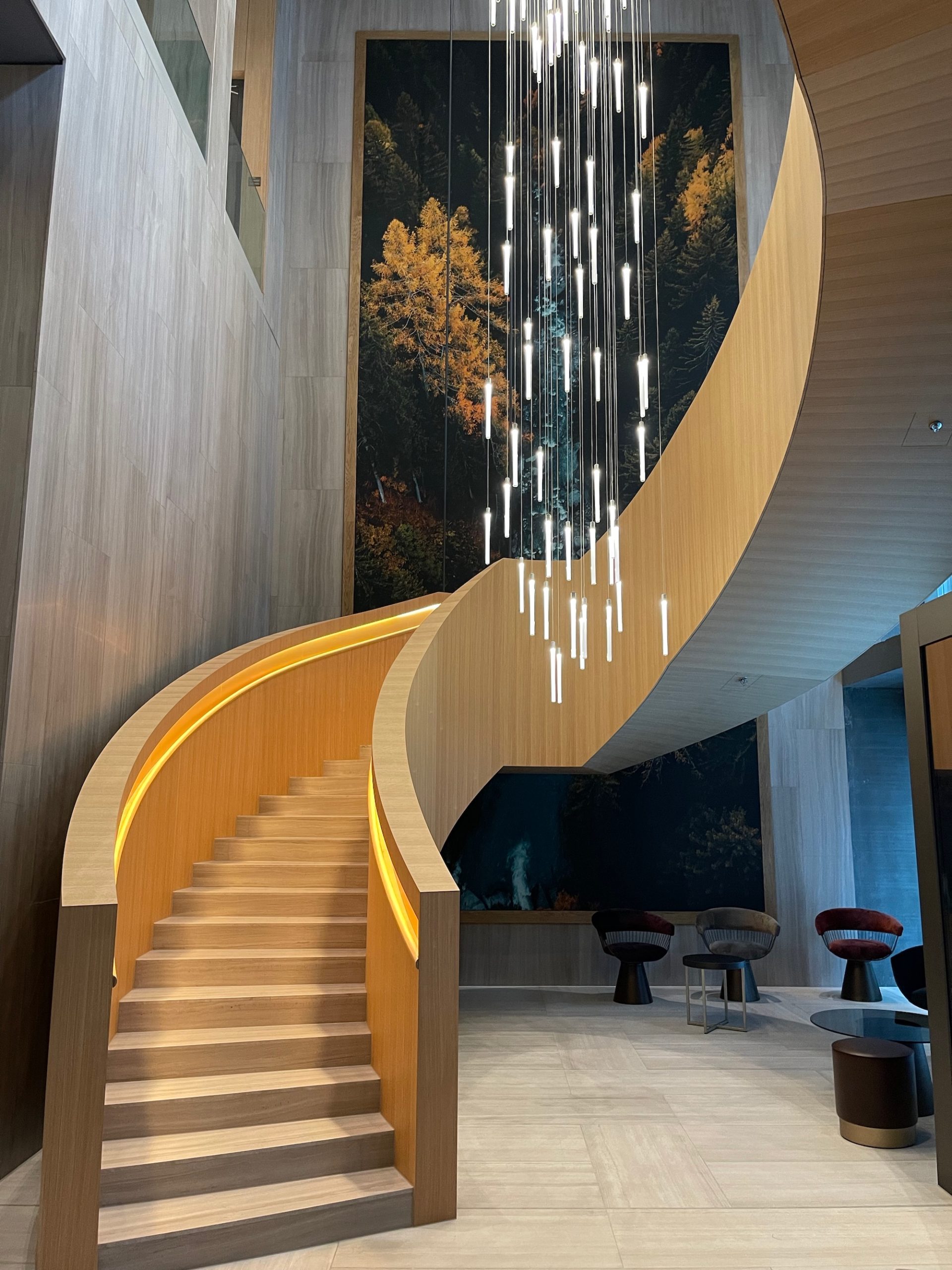 a staircase with lights from the ceiling