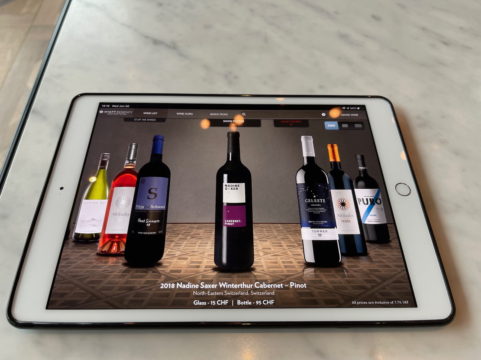 a tablet with a picture of wine bottles on the screen