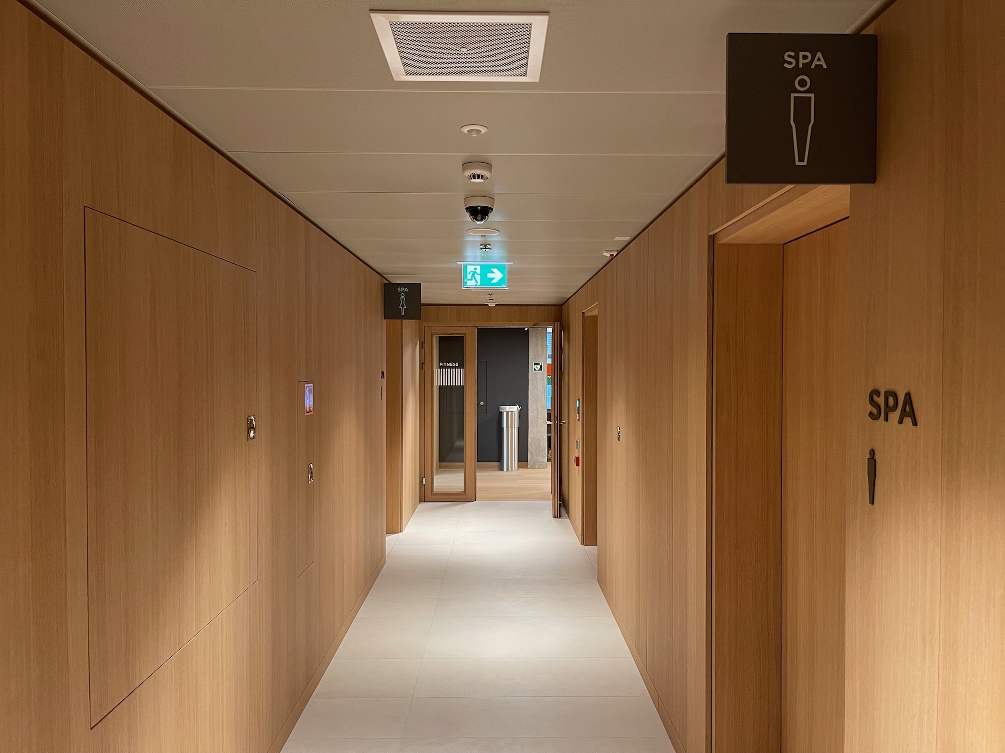 a long hallway with wooden walls and signs