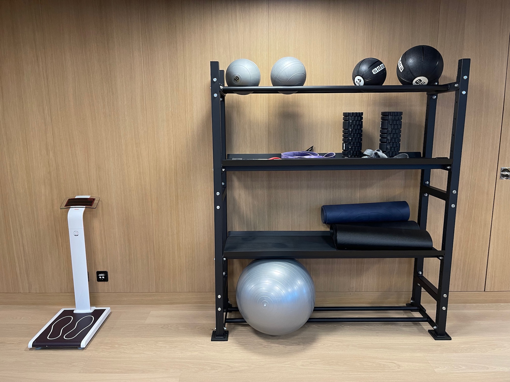 a shelf with a ball and yoga mat on it
