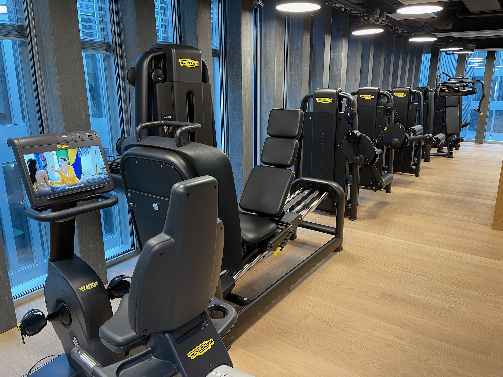 a row of exercise machines in a gym