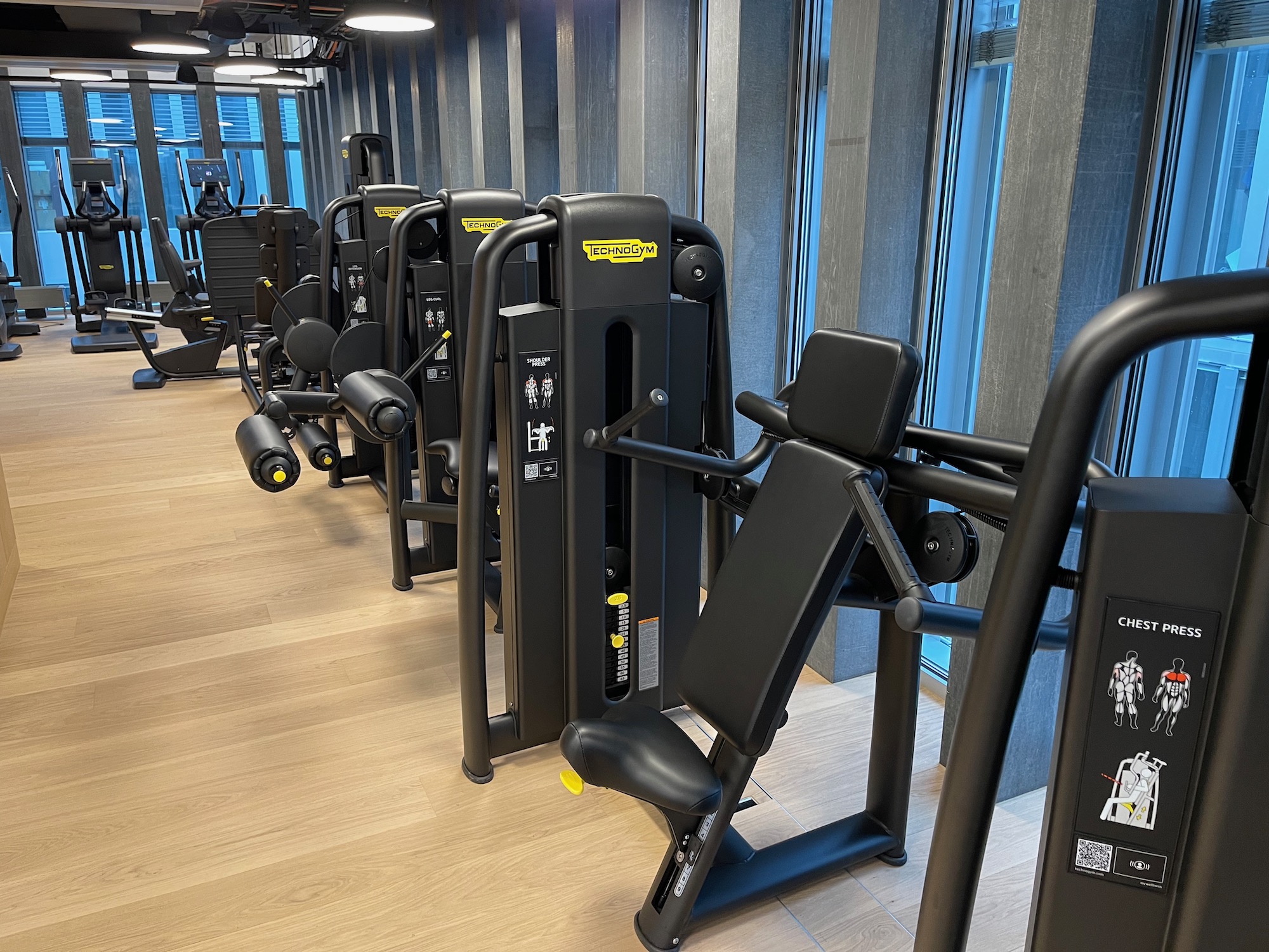 a row of exercise equipment in a gym