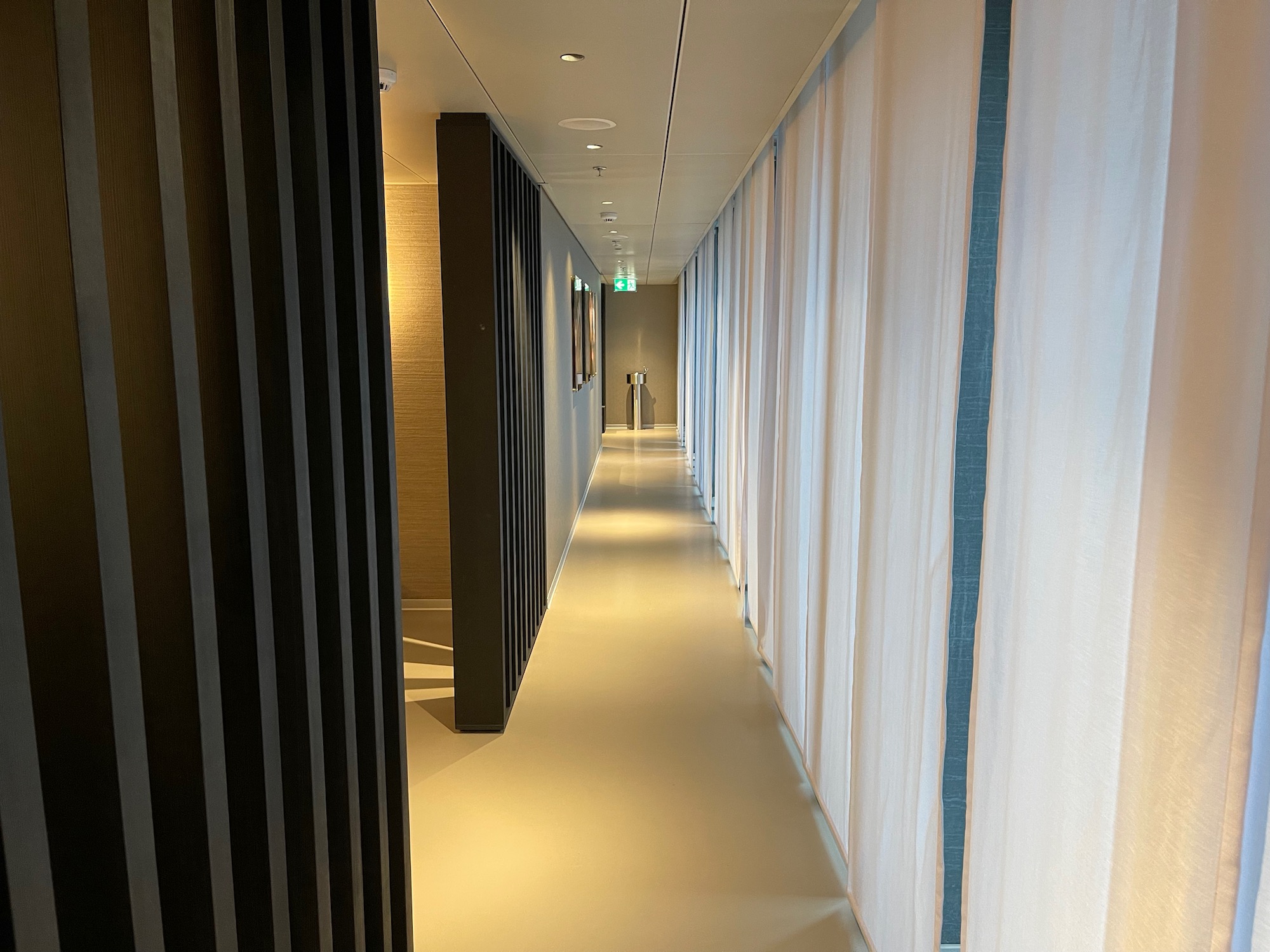 a long hallway with white curtains