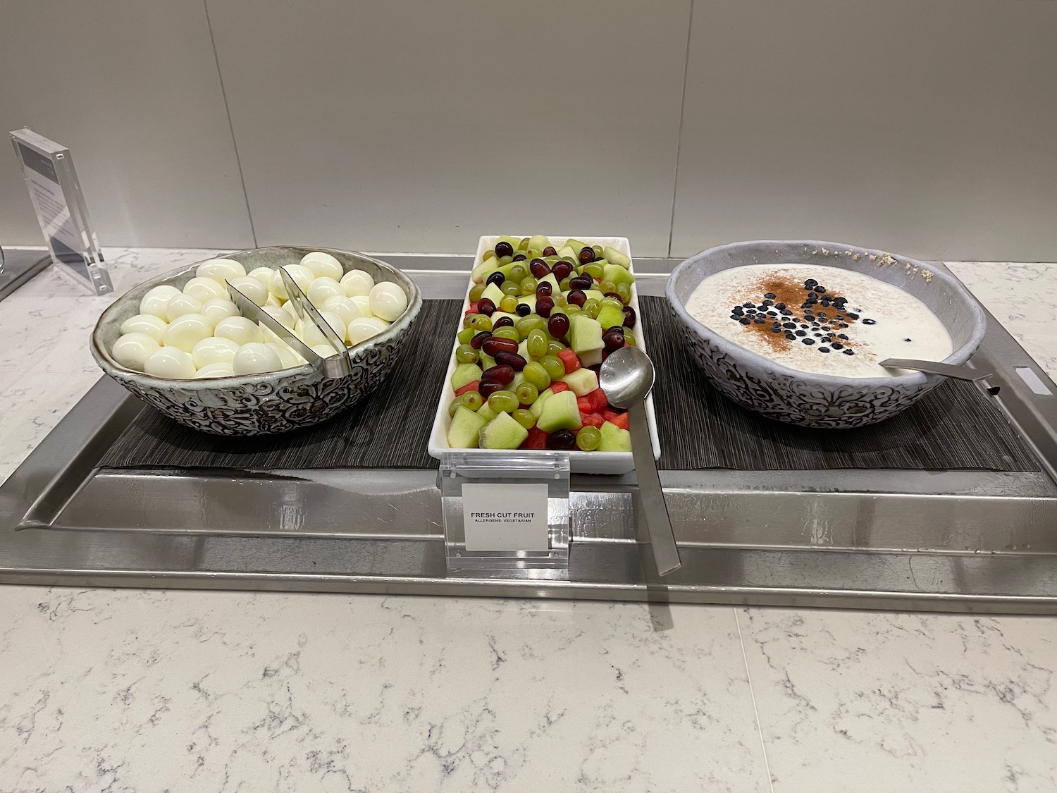 a tray of fruit and yogurt bowls