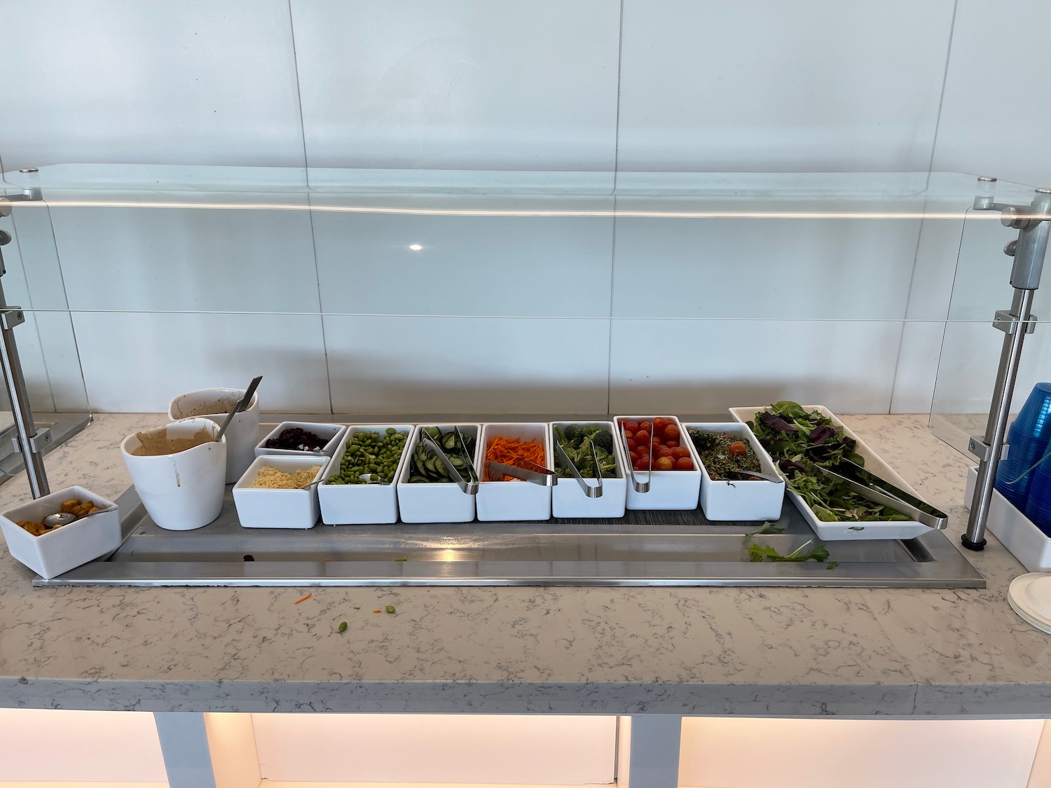 a row of containers of vegetables