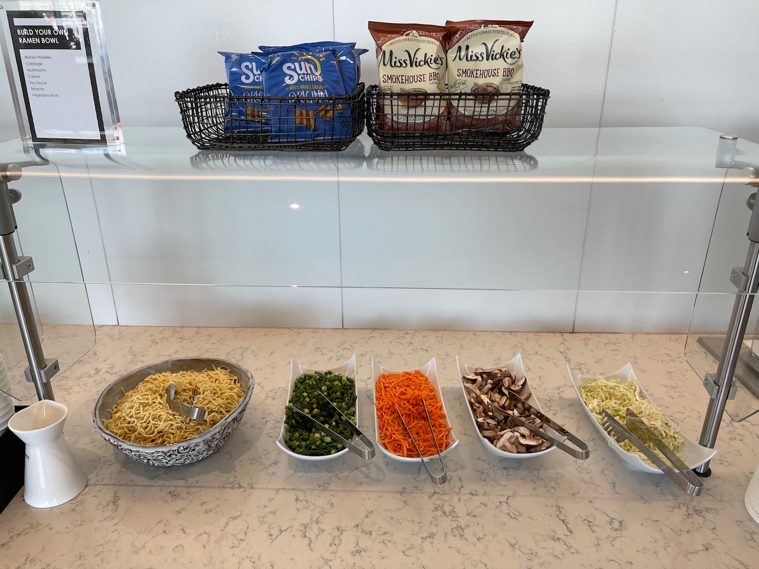 a row of bowls of food on a counter