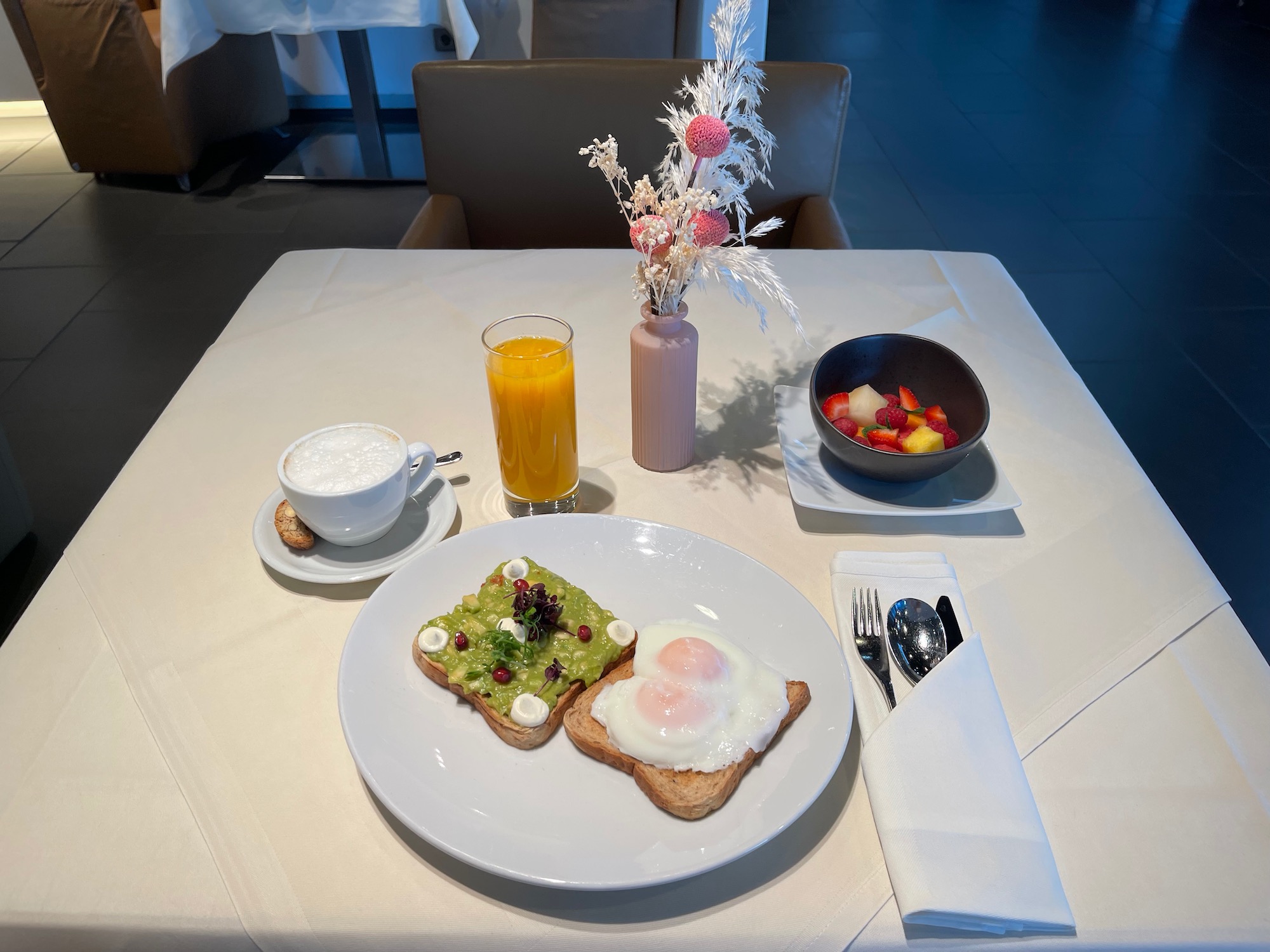 a plate of toast with eggs and fruit on it