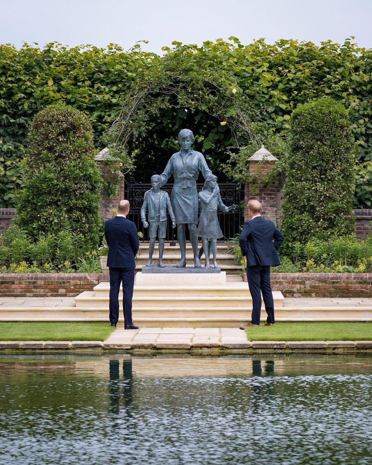 a group of people standing in front of a statue