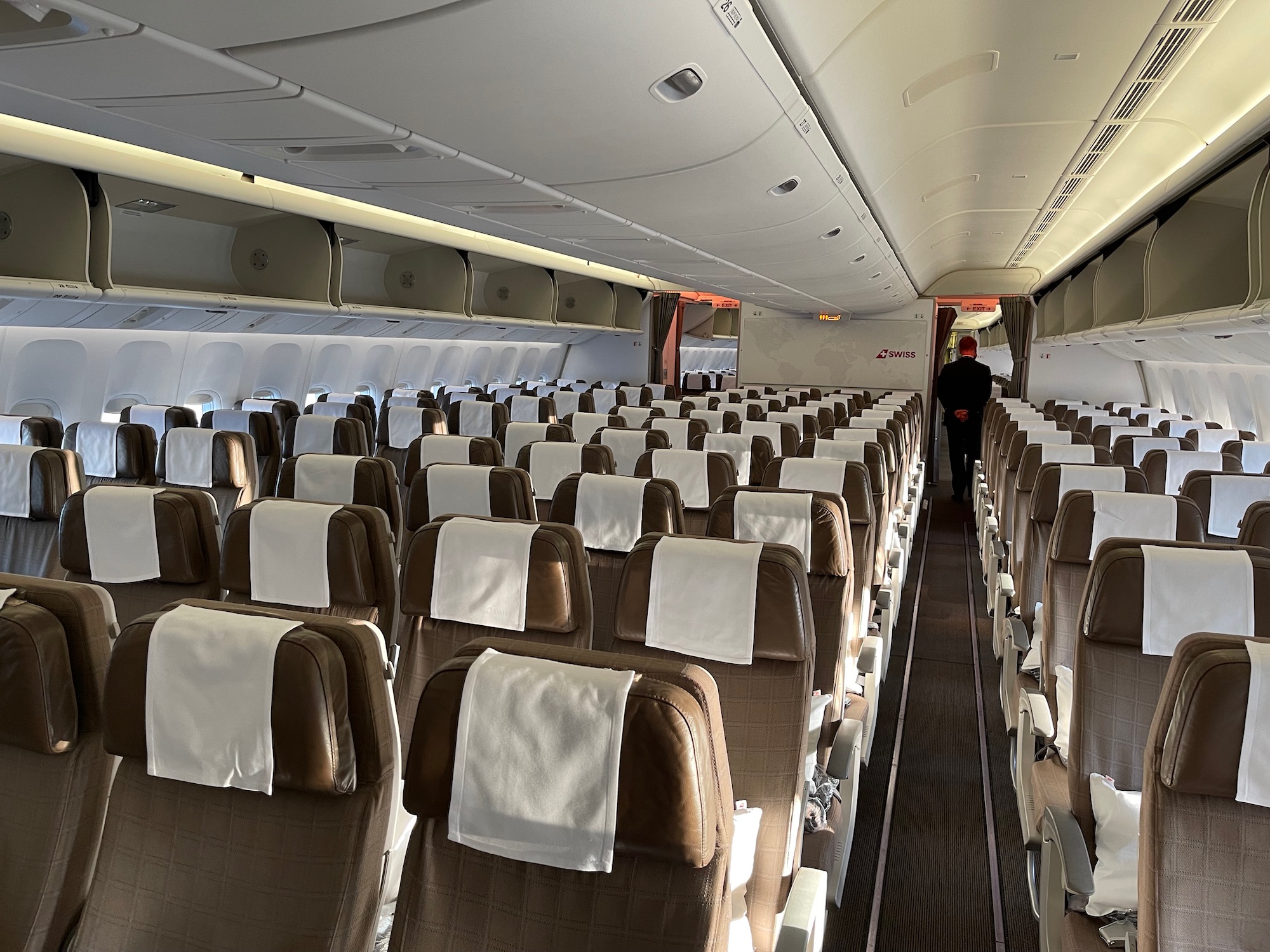 an airplane with seats and a person standing in the back