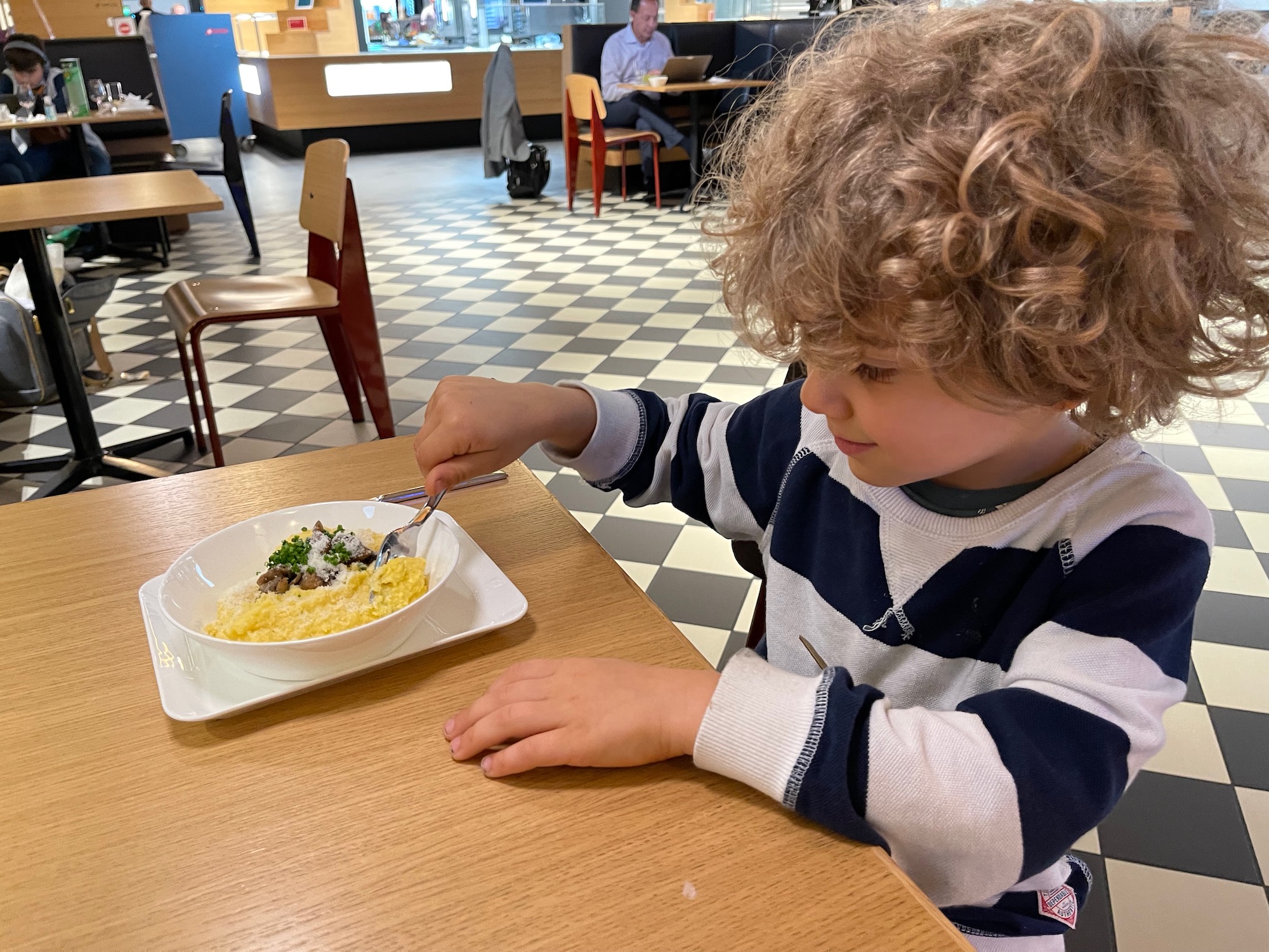 a child eating food at a table