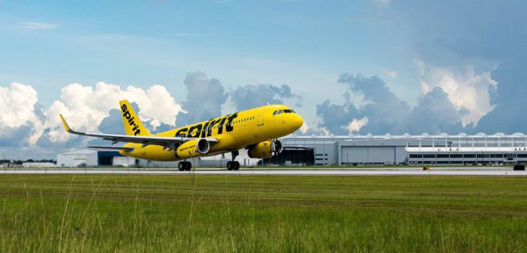 a yellow airplane on a runway