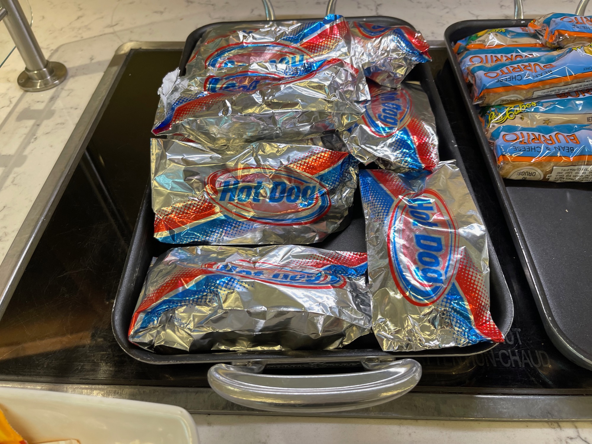 a tray of hot dog wrapped in foil