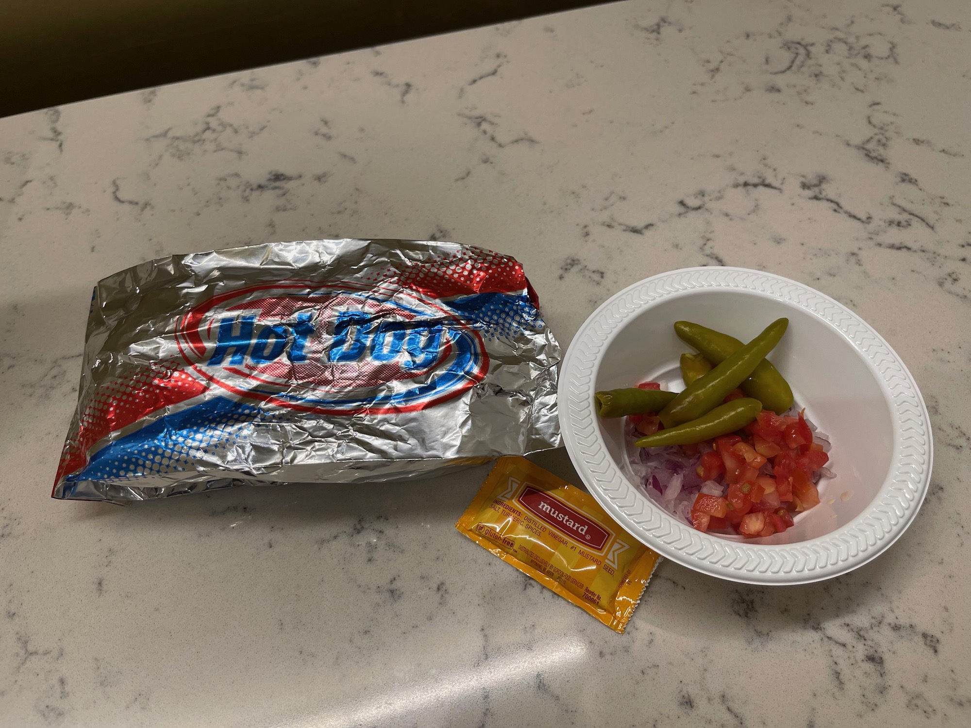 a bowl of food and a packet of chips