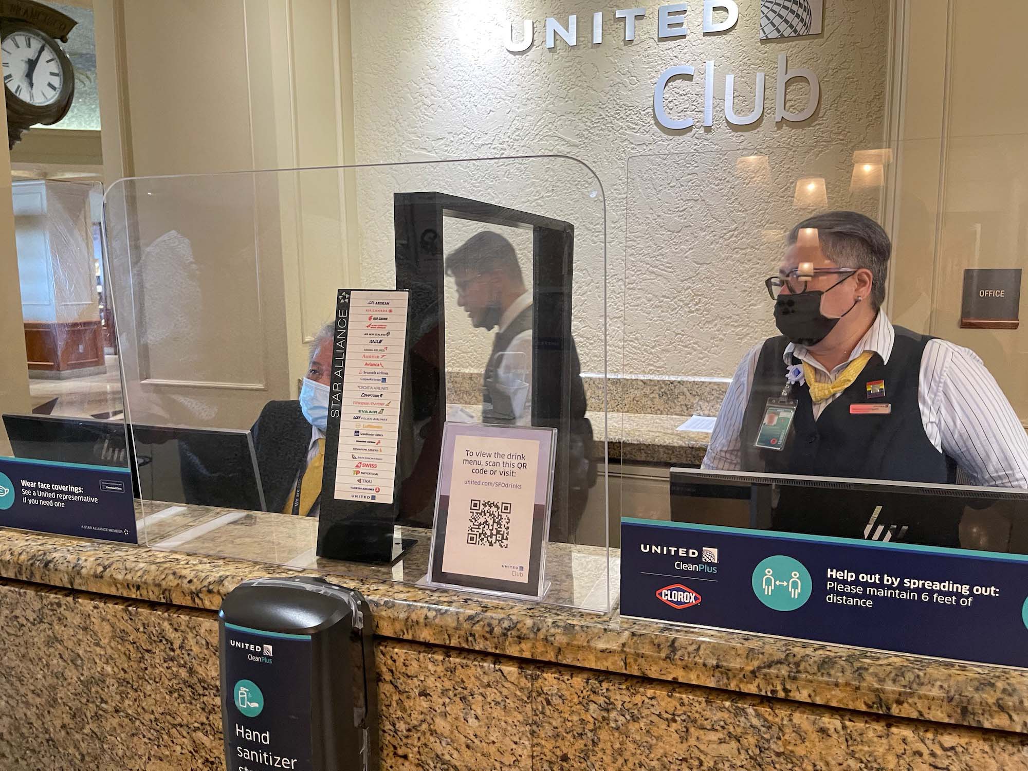 a man wearing a face mask behind a counter