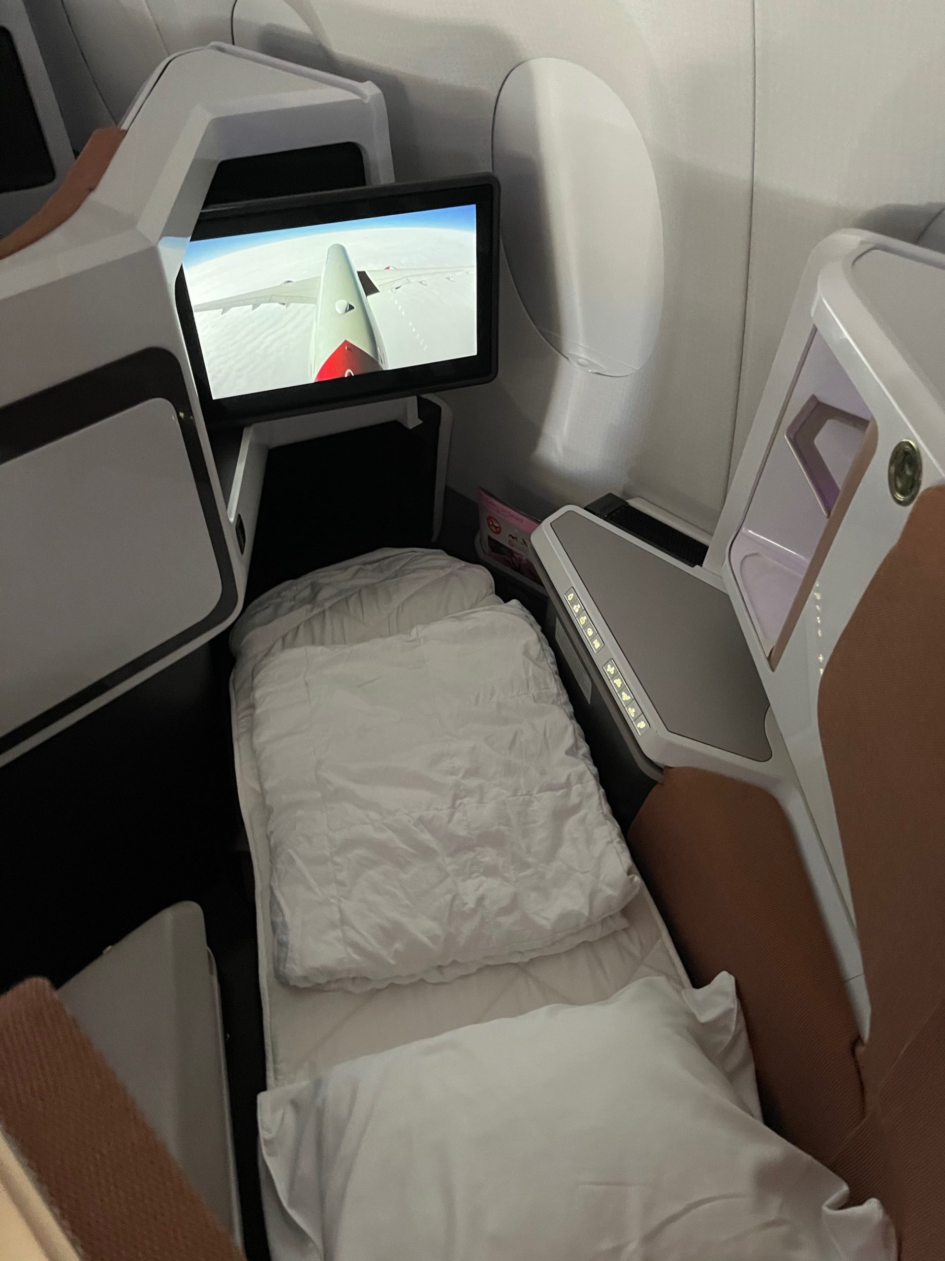 a bed and a tv in a plane