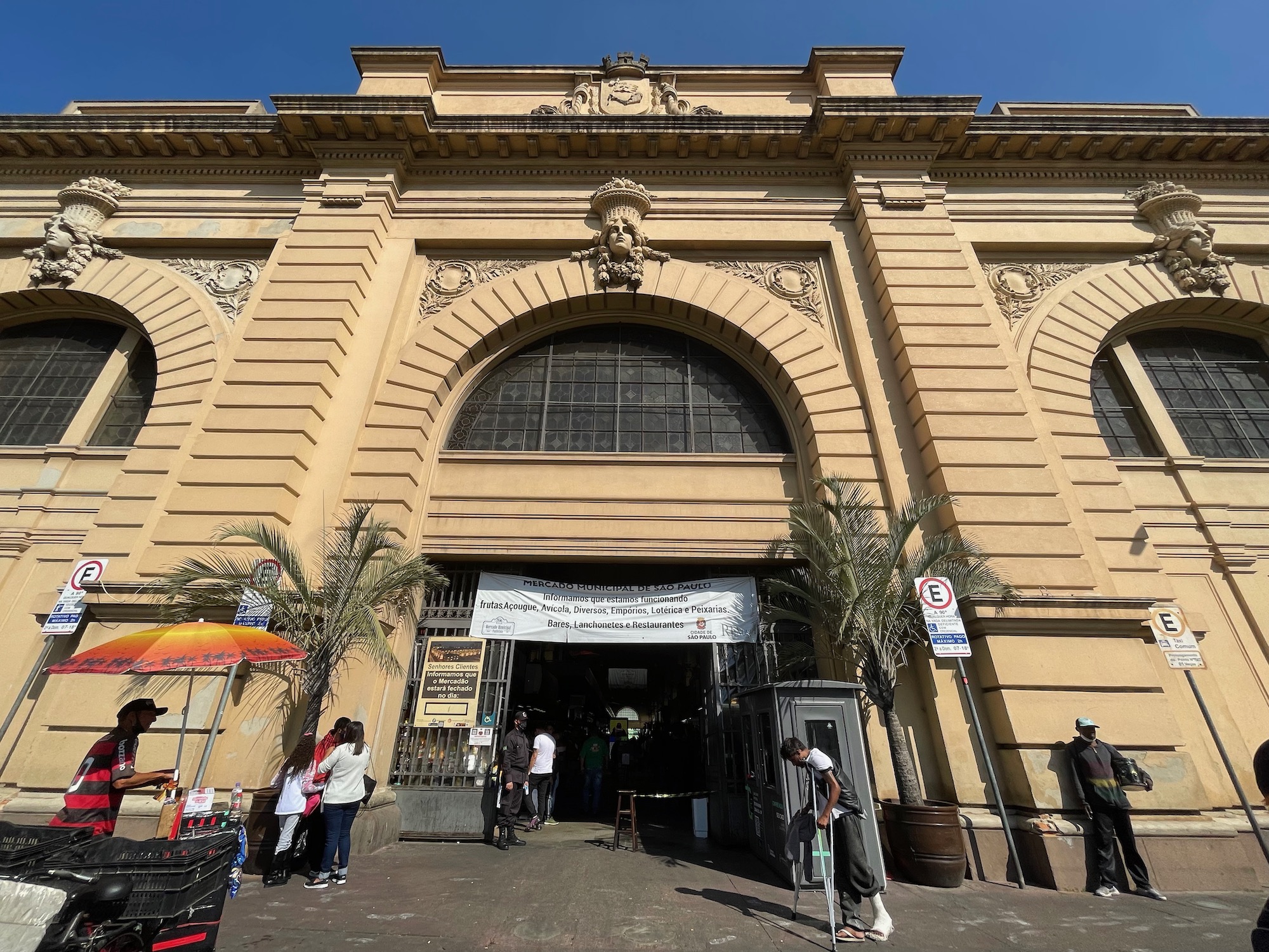 a large building with people walking in the street