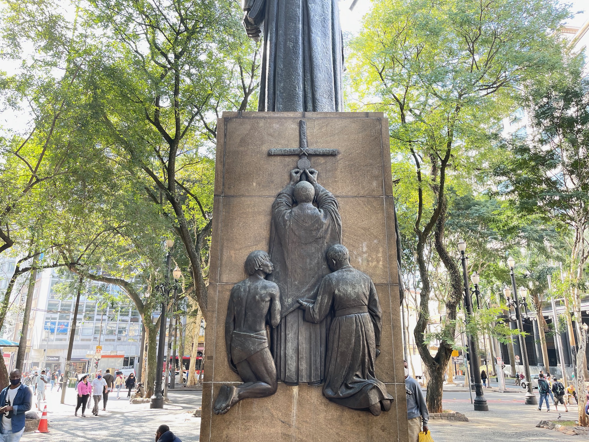 a statue of a man kneeling on a cross and a woman kneeling on a cross