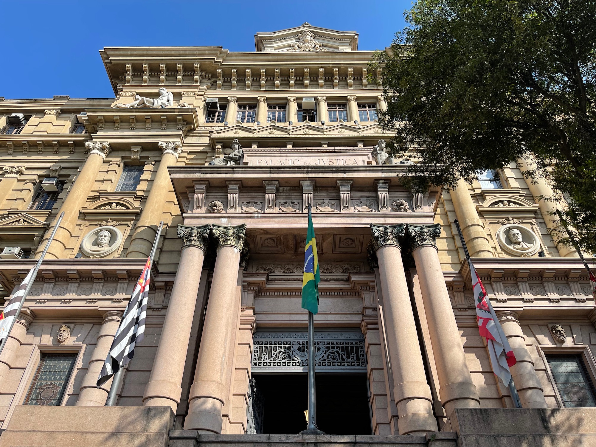 a building with columns and flags