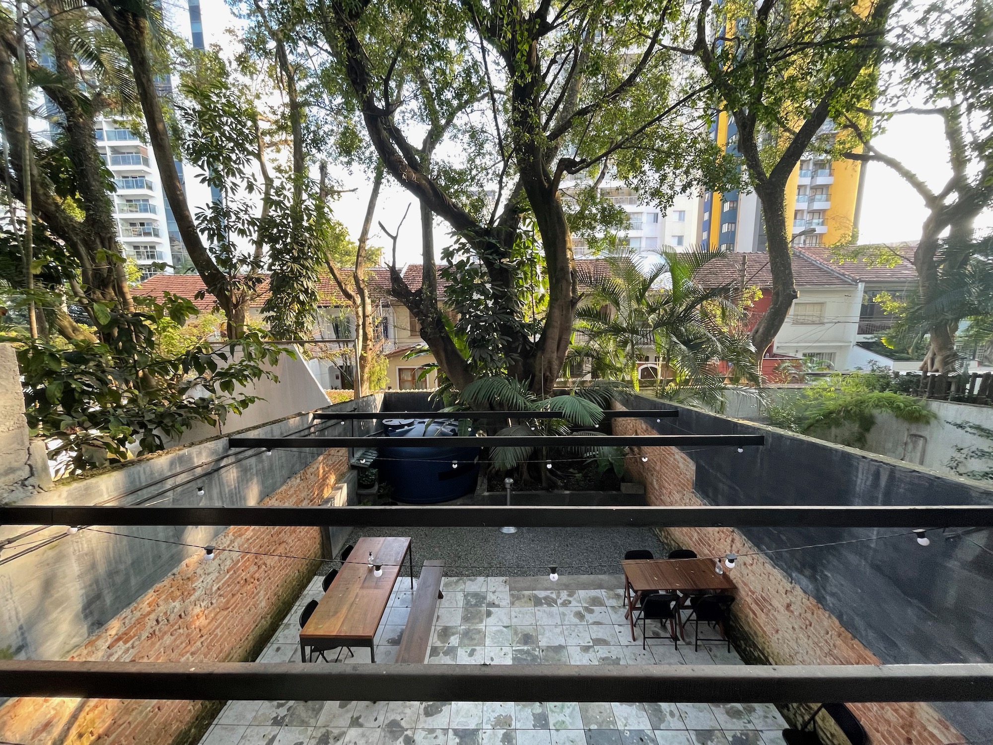 a patio with a tree and benches