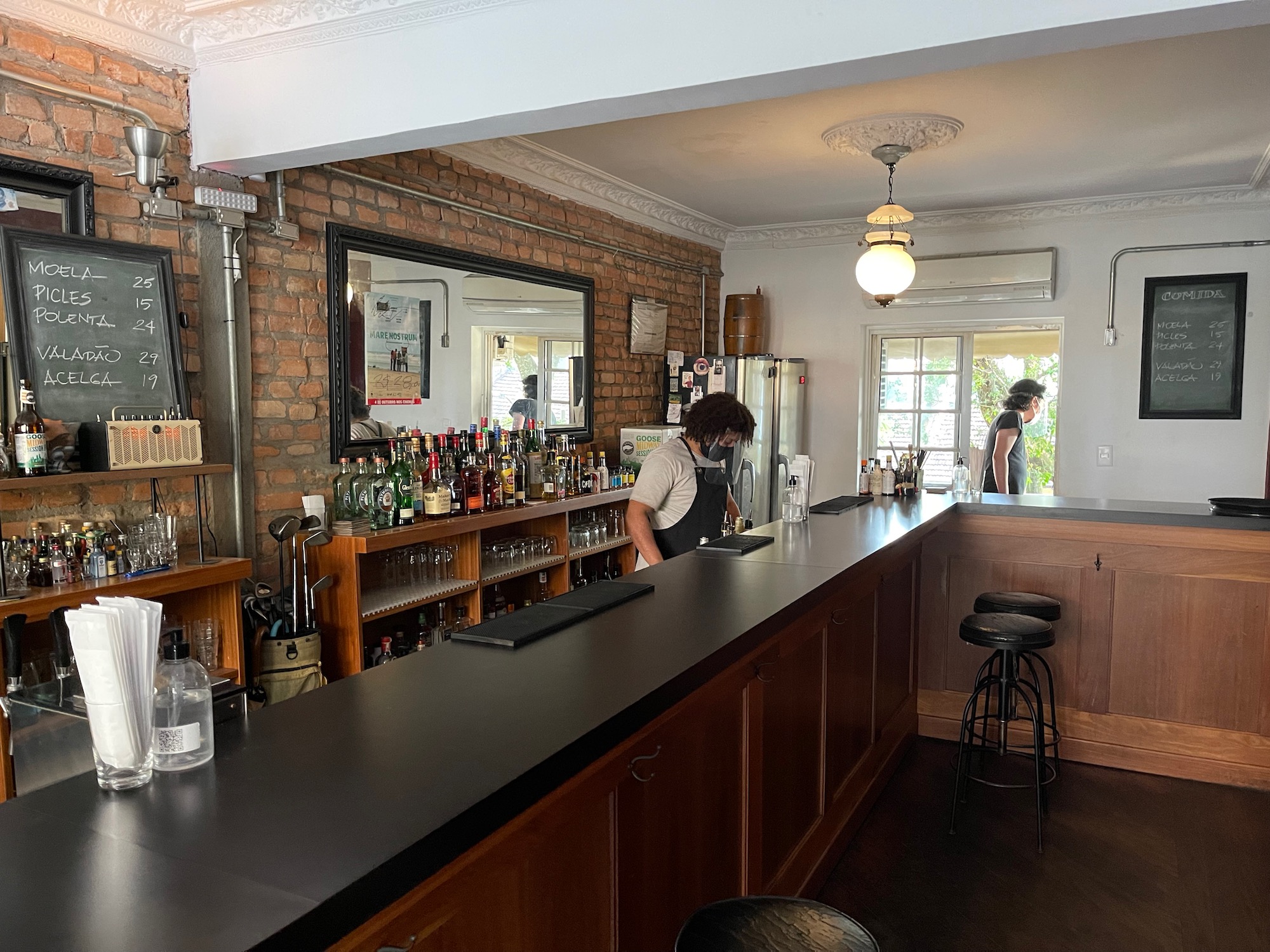 a man standing behind a bar