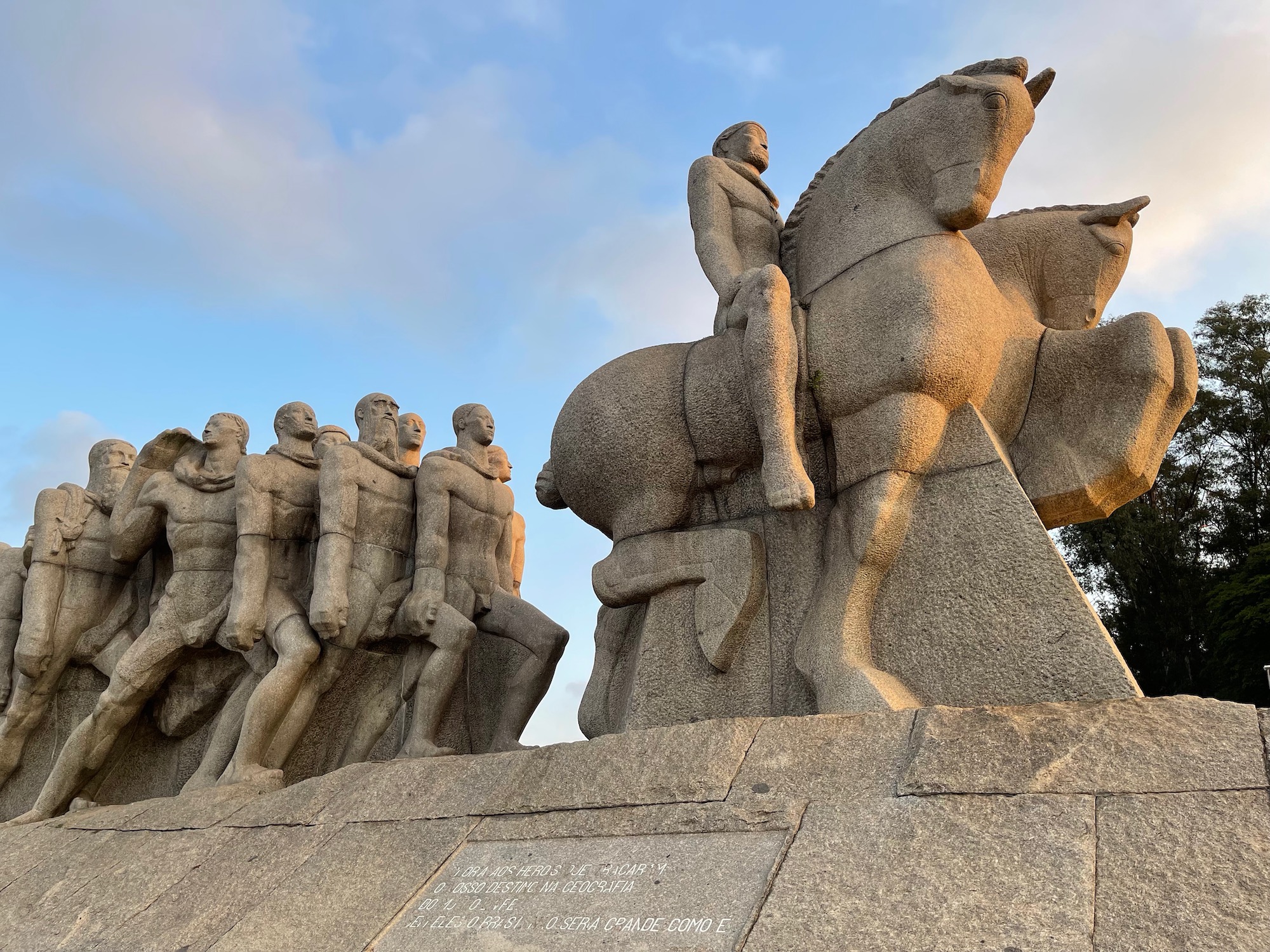 a stone statue of men riding horses