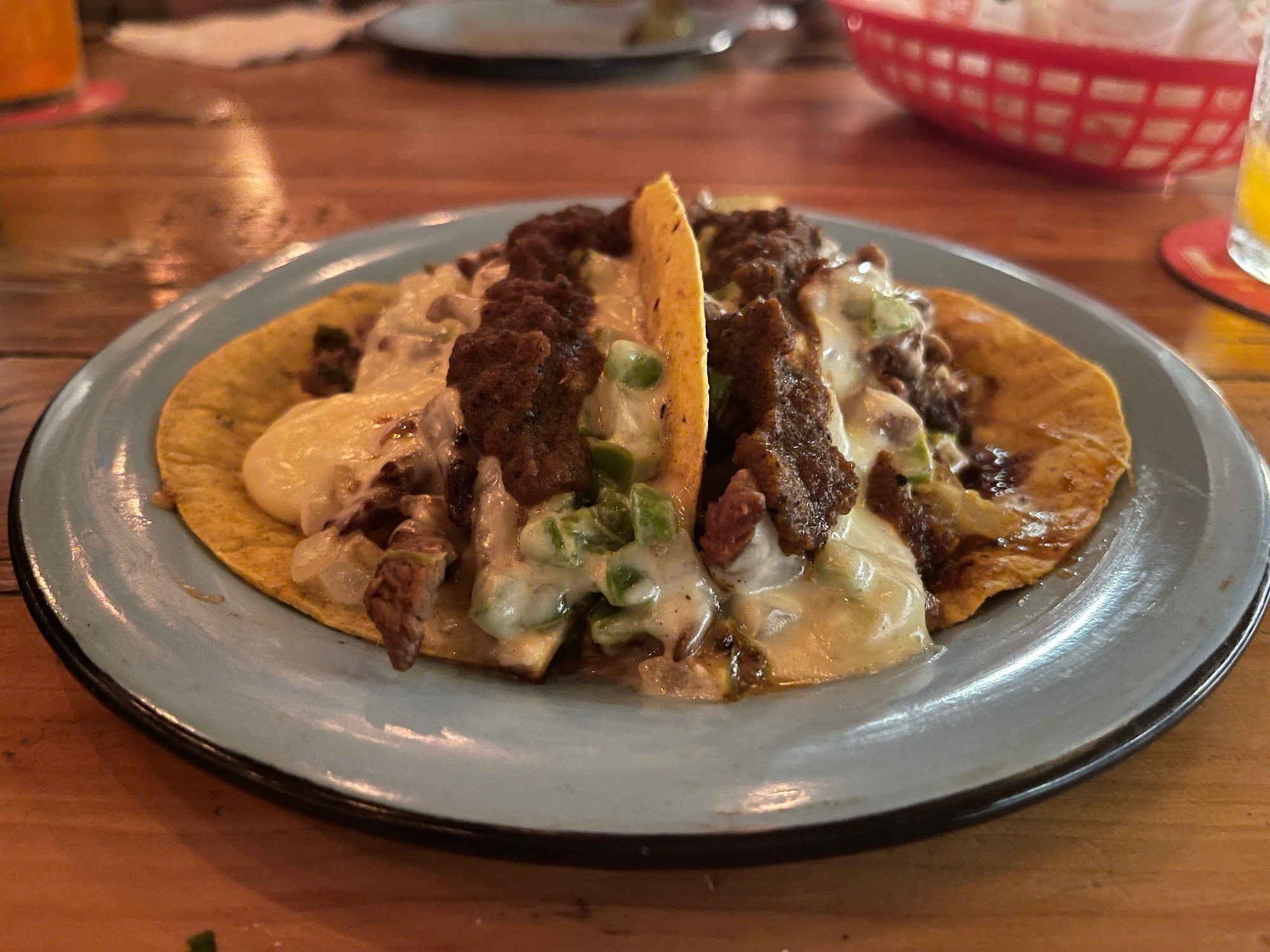 a plate of tacos with meat and cheese