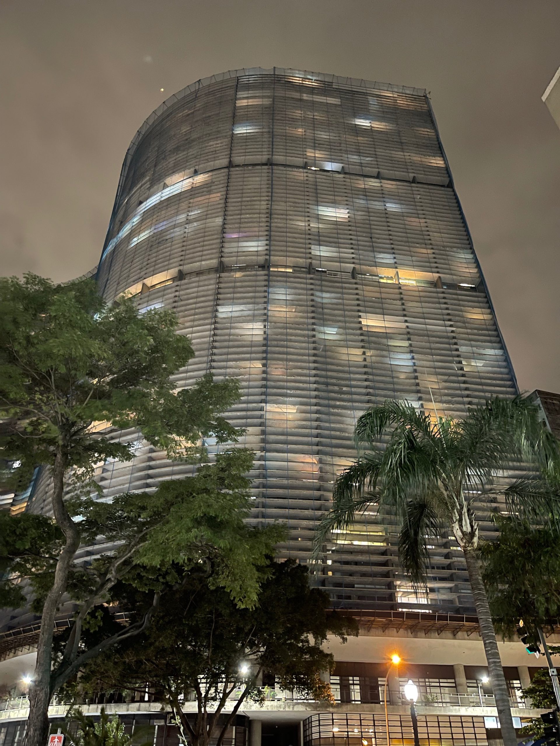 a tall building with trees in front of it