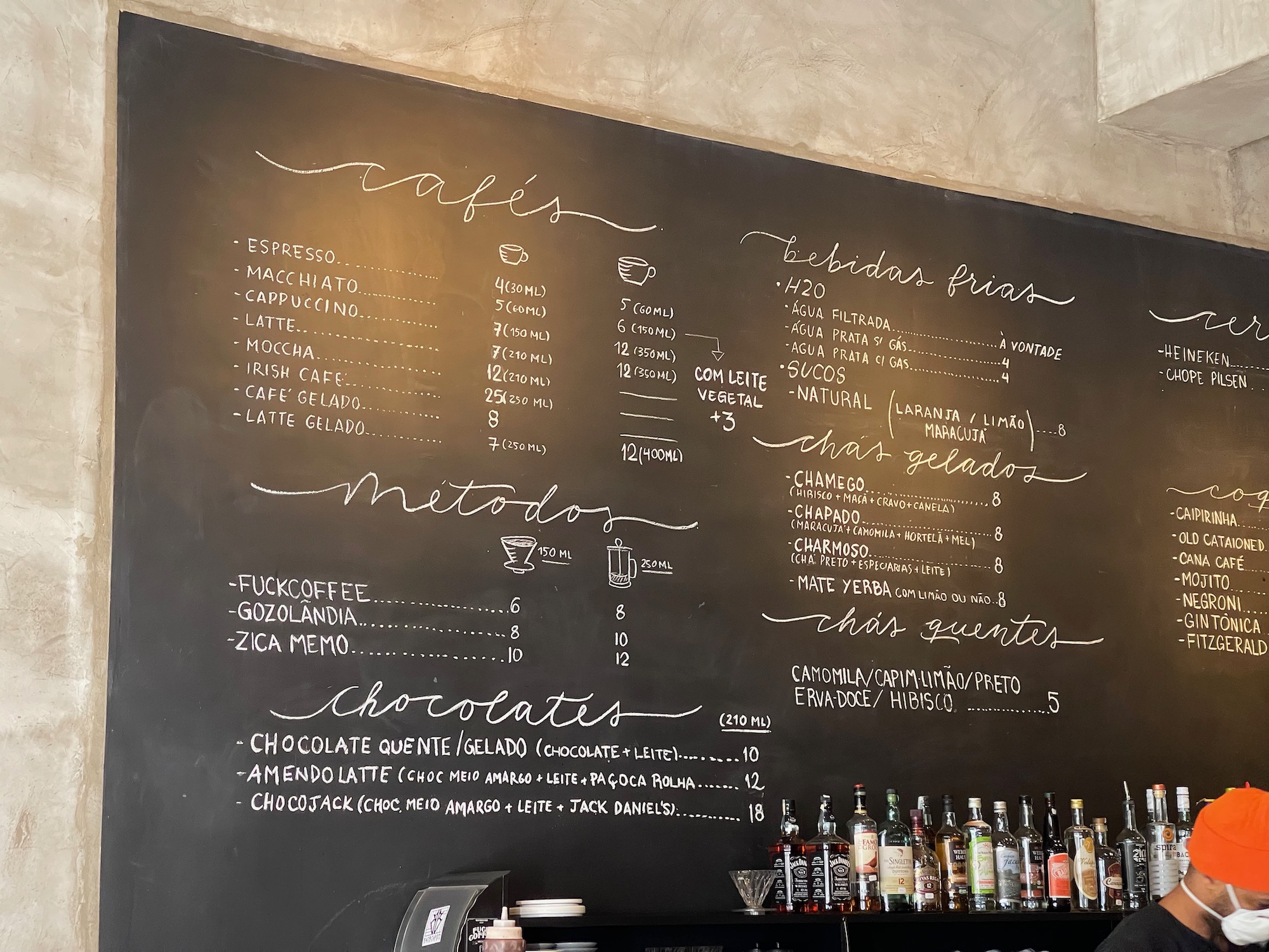 a menu board with bottles of liquor on it