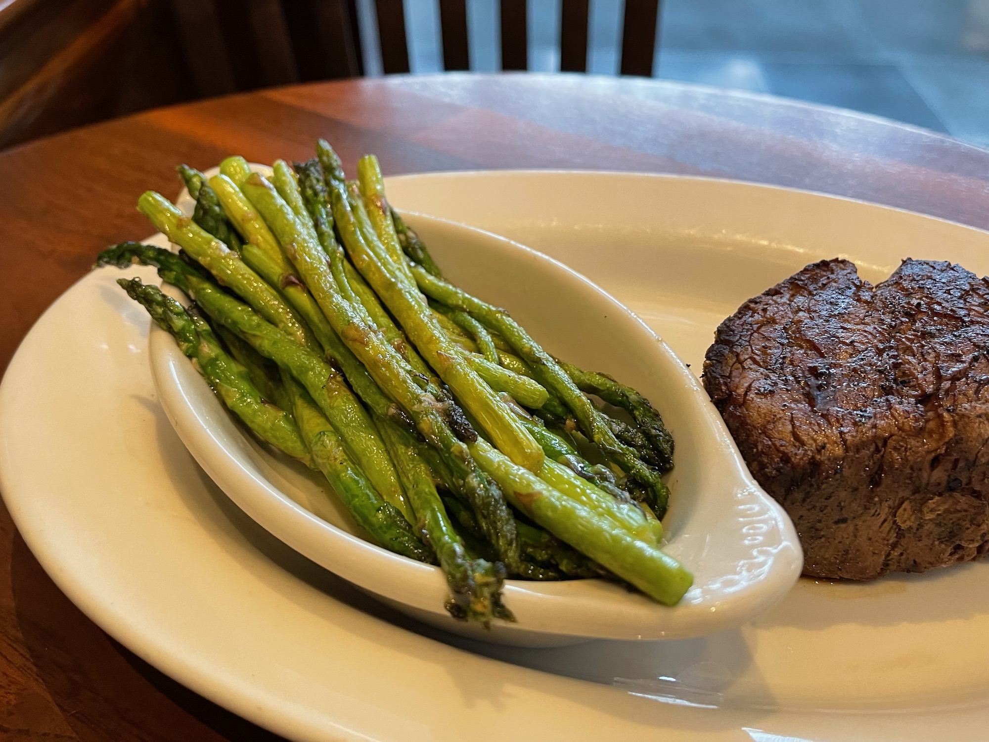 a plate of asparagus and steak