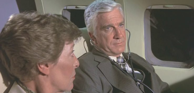 a man and woman sitting on an airplane