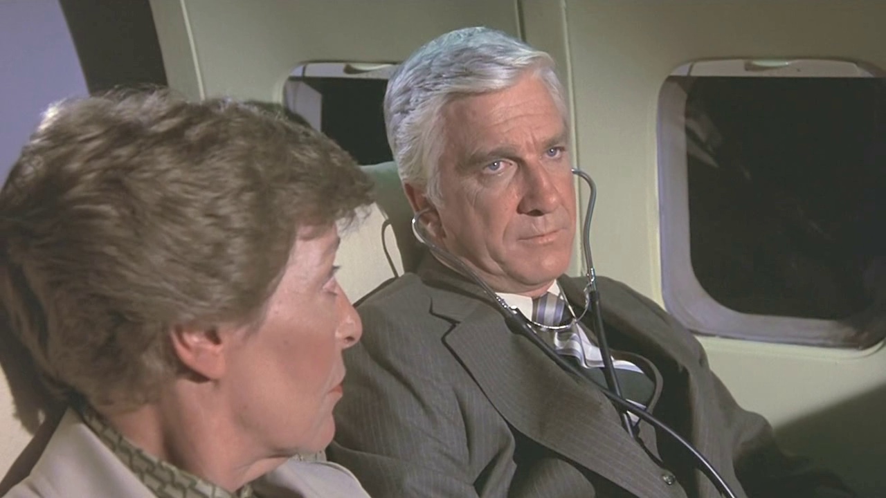 a man and woman sitting on an airplane