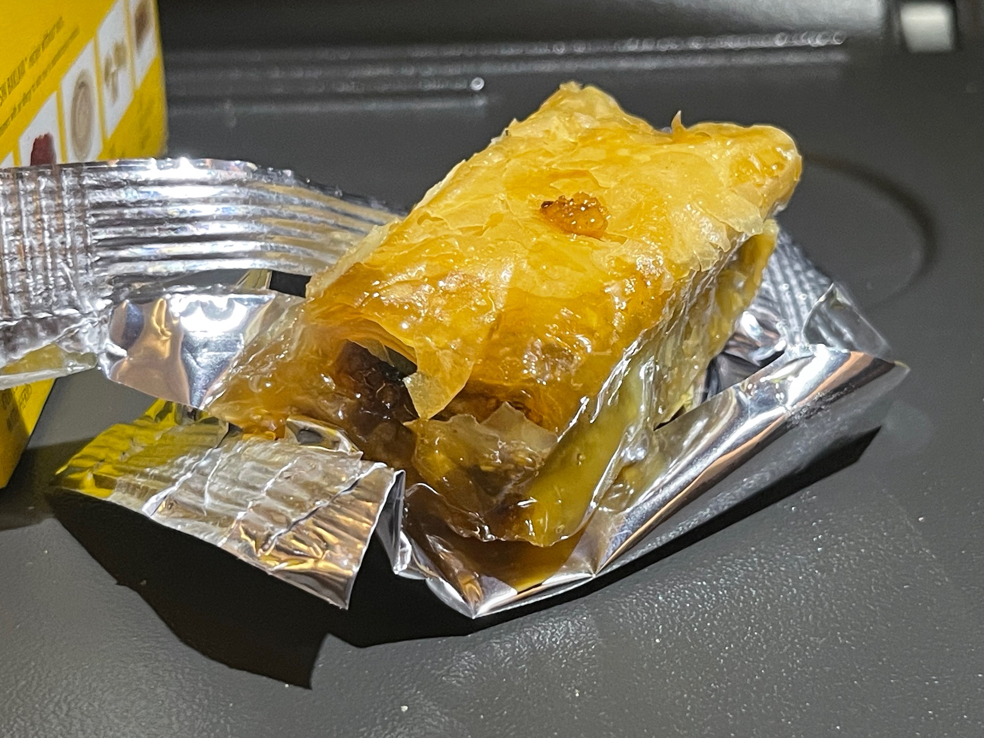 a piece of food in a foil wrapper