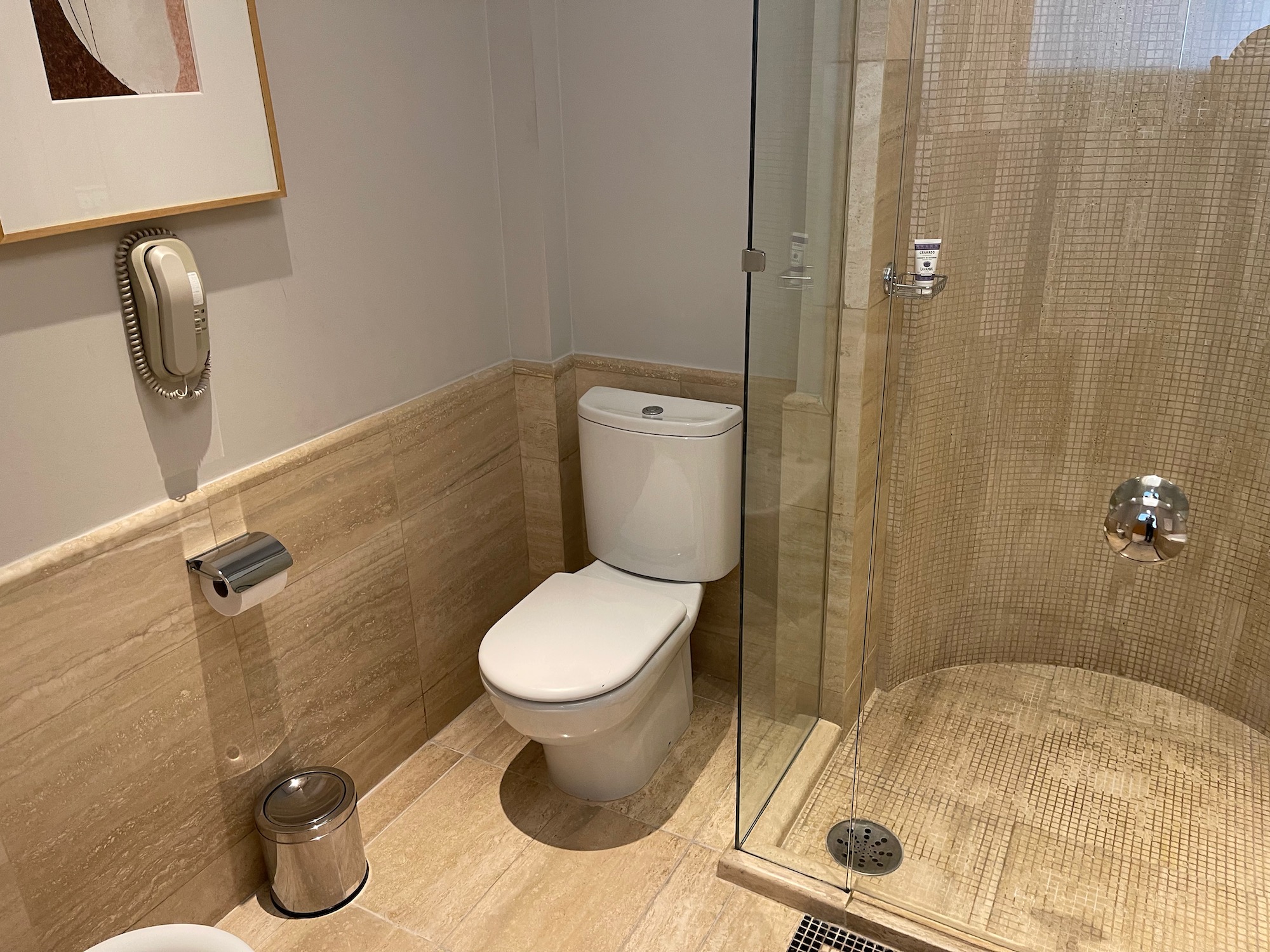 a bathroom with a glass shower and toilet