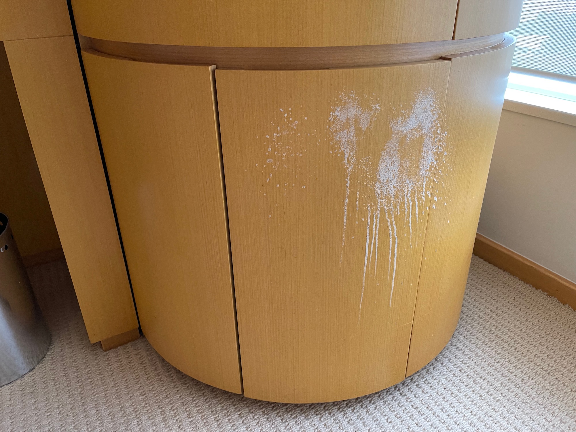 a white powder on a wooden cabinet