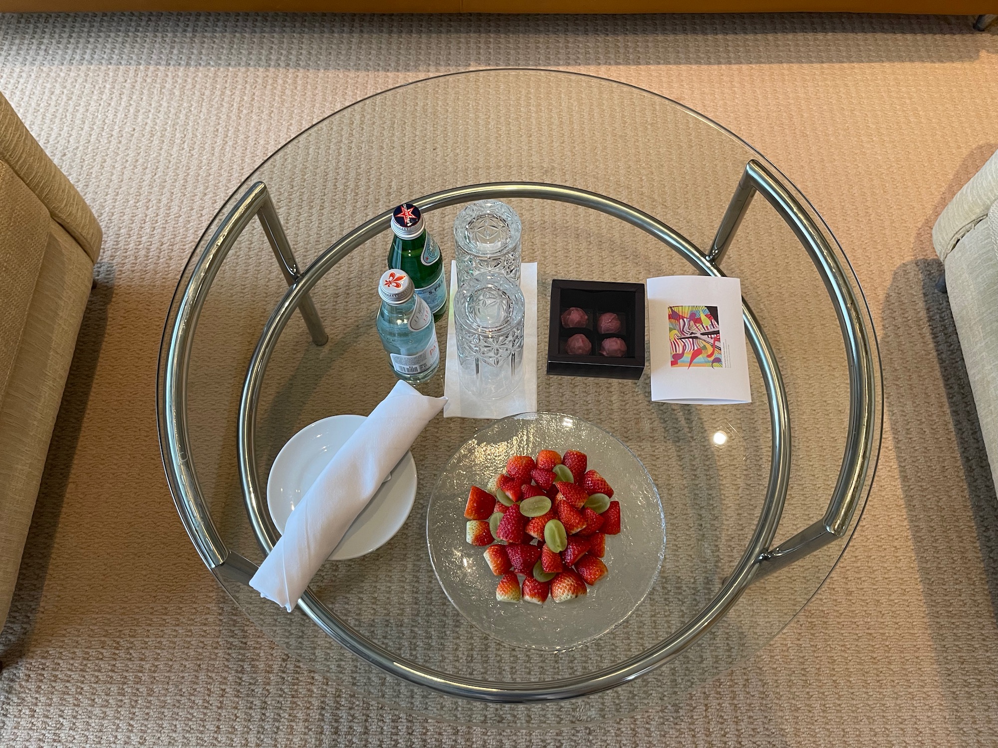 a glass table with food and drinks on it