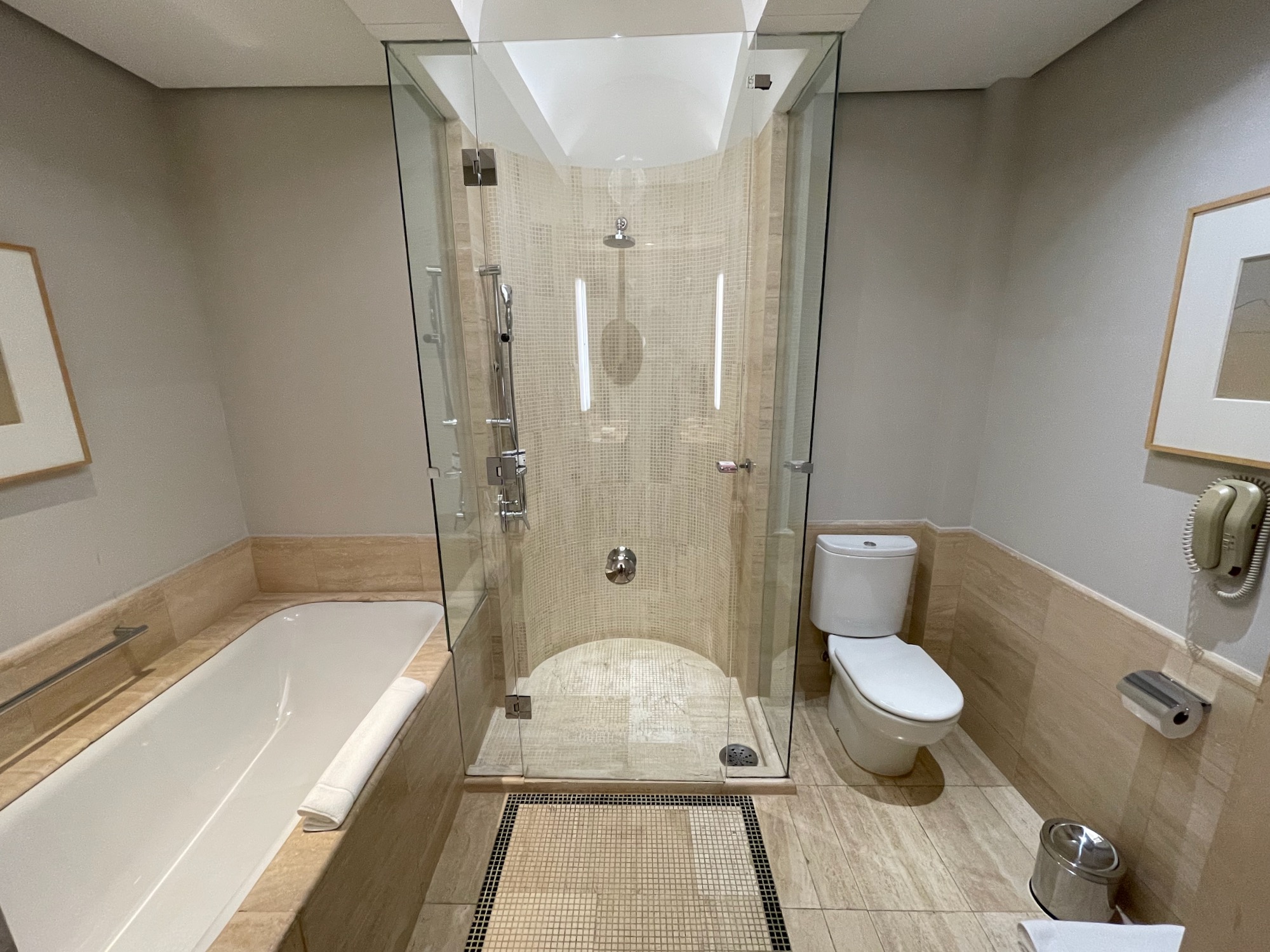 a bathroom with a glass shower and bathtub