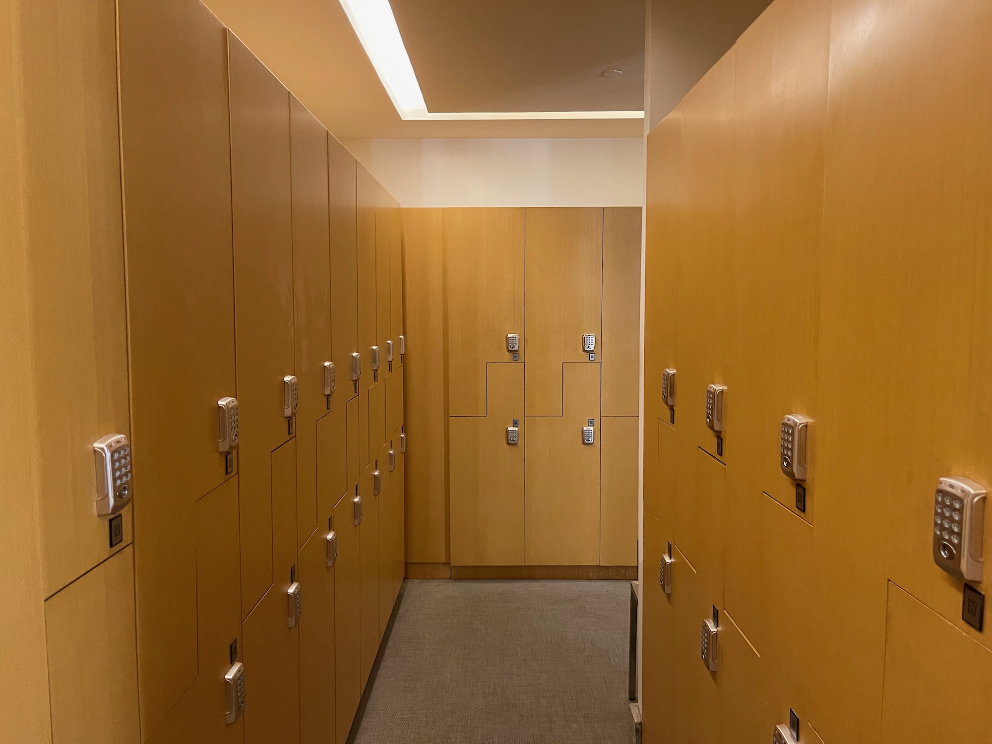 a hallway with lockers and a light fixture