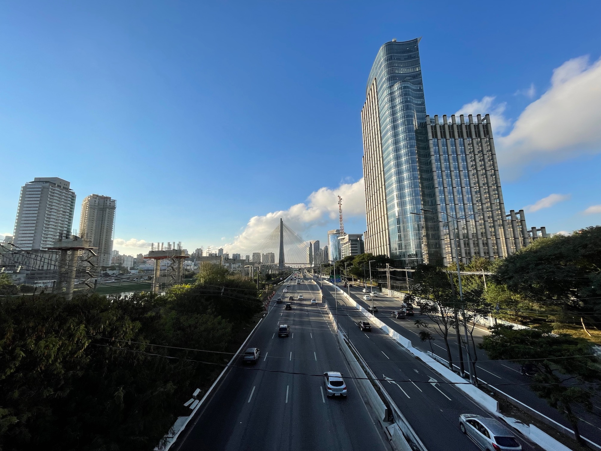 a road with cars and buildings in the background